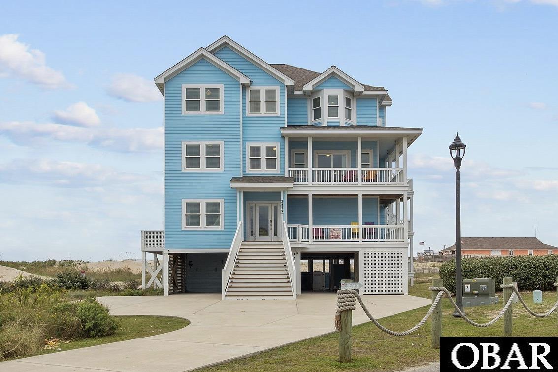 With over $250,000 in owner rental income for 2023, Blue Ocean Views is the epitome of everything a beautiful, well-maintained 8 bedroom (all masters) oceanfront home should offer- and it shows with consistently increasing rental revenue every year through 2023!!! The decks and a pool area loaded with custom poly furniture, an expanded pool area with custom decking, custom leather seats in the home theater with projector and screen, 2 large owners closets built on ground level and updated painting and decor throughout. There's plenty of room and amenities for everyone- including unlimited use pier passes for all guests to the adjacent Rodanthe Pier and a game room on the lower level. Schedule your Saturday showing now! Ground level provides both charcoal and gas grill, pool, hot tub, chaises, adirondack chairs as well as a bar height tables and stools, stairwell for covered entry and elevator access. Upon entering the lower level in the home, you'll find the theater room, game room with pool table, TV, full refrigerator, wet bar and 1/2 bath, bunk room with double bunks and attached full bath, king bedroom with master bath and laundry room. The mid-level offers another bunk room with double bunks and attached full bath as well as 3 king bedrooms all with connected baths. The west-facing master bedroom also has a wheelchair accessible shower. Ascending to the top level, you'll be greeted by sweeping ocean views, the spacious great room with adjacent dining table and kitchen offering amenities galore. You'll find 2 dishwashers, 2 wall ovens, a wine fridge and ample room to soak in the calming ocean vibes. There is also a 1/2 bathroom and 2 additional king master bedrooms located on the top floor- the east-facing master with deck access as well. Location and views are everything here!! Rare X flood zone for an Oceanfront home and located south of where the new Rodanthe Jug Handle south entry point lies. Don't miss this opportunity!