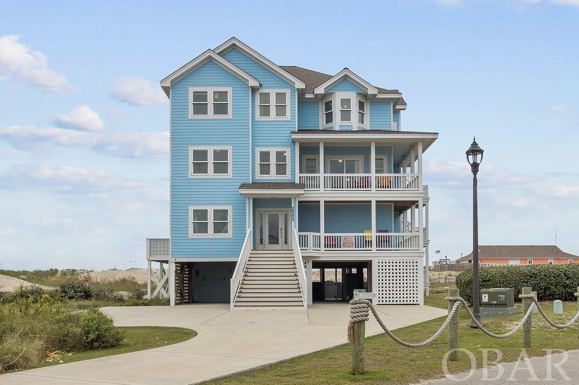 With over $250,000 in owner rental income for 2023 and over $150K already on the books for 2024, Blue Ocean Views is the epitome of everything a beautiful, well-maintained 8 bedroom (all masters) oceanfront home should offer- and it shows with consistently increasing rental revenue every year through 2023!!! The decks and a pool area loaded with custom poly furniture, an expanded pool area with custom decking, custom leather seats in the home theater with projector and screen, 2 large owners closets built on ground level and updated painting and decor throughout. There's plenty of room and amenities for everyone- including unlimited use pier passes for all guests to the adjacent Rodanthe Pier and a game room on the lower level. Schedule your Saturday showing now! Ground level provides both charcoal and gas grill, pool, hot tub, chaises, adirondack chairs as well as a bar height tables and stools, stairwell for covered entry and elevator access. Upon entering the lower level in the home, you'll find the theater room, game room with pool table, TV, full refrigerator, wet bar and 1/2 bath, bunk room with double bunks and attached full bath, king bedroom with master bath and laundry room. The mid-level offers another bunk room with double bunks and attached full bath as well as 3 king bedrooms all with connected baths. The west-facing master bedroom also has a wheelchair accessible shower. Ascending to the top level, you'll be greeted by sweeping ocean views, the spacious great room with adjacent dining table and kitchen offering amenities galore. You'll find 2 dishwashers, 2 wall ovens, a wine fridge and ample room to soak in the calming ocean vibes. There is also a 1/2 bathroom and 2 additional king master bedrooms located on the top floor- the east-facing master with deck access as well. Location and views are everything here!! Rare X flood zone for an Oceanfront home and located south of where the new Rodanthe Jug Handle south entry point lies. Don't miss this opportunity!