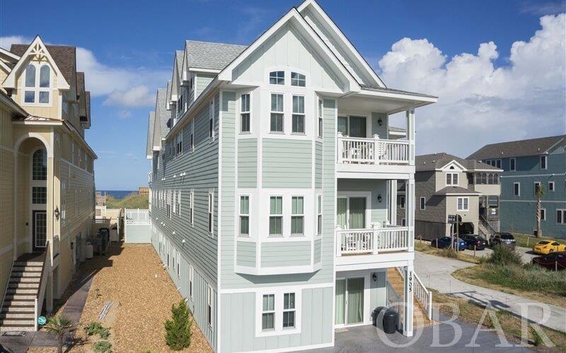 “Seas the Day” and seize the opportunity to own this classic 15 bedroom, 10,000 s.f. home! This sleek and stylish investment will make you and your guests happy while on vacation. The $470k in rental income will help you retire early so you can vacation even more! Built in 2014, this beauty has everything you want and more in a large oceanfront vacation home! Professionally managed by Carolina Designs Realty since it was new, this investment comes with a management team and an established history of repeat renters and positive reviews. Below are just a few highlights of the many features that you must see: Throughout the home there is a tasteful blue and sand motif that is classic and cool! The great room is properly sized with soaring 16 foot ceilings and beautiful windows framing incredible views. The kitchen is meticulously planned for the convenience of just a few or for cooking and serving a large group. The game room is one of the best on the beach with ample size, incredible views and stylish touches like the custom bar and cork floor. The tiered theater is comfortable for two or twelve or more! The fourth floor king suite is large enough for a small family. Four of the bedroom suites feature couches and more than ample size which guests love. The covered decks on the front and back are prefect places to enjoy the outdoors. The pool, fountain, wading pool and entire outdoor living area stand out from the competition! This section of beach is the gold standard of stability on the Outer Banks! Everyone loves the central location within easy walking distance to great restaurants!