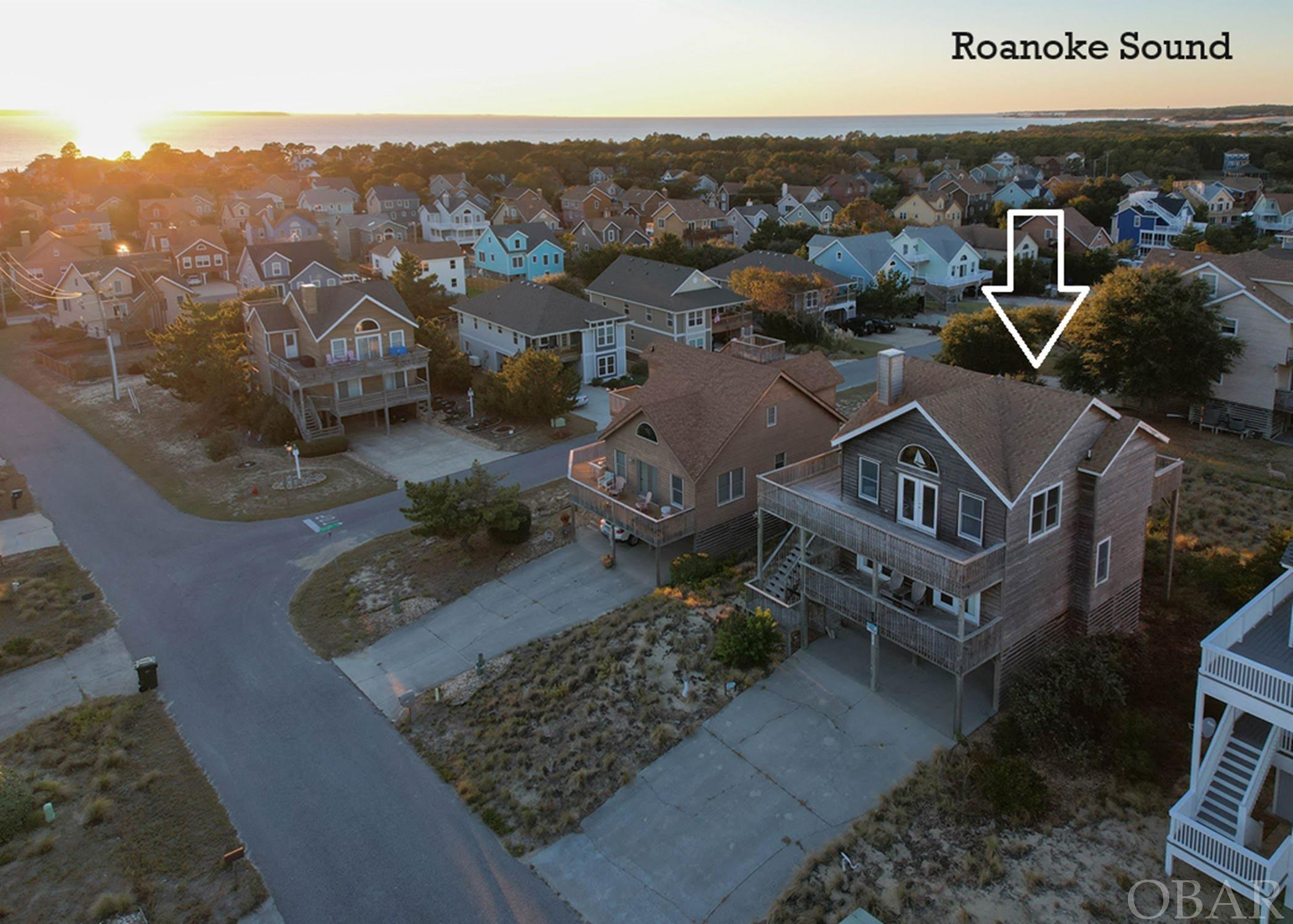 ON TOP OF THE OBX!  Views AND Location!  Check out this new listing today!  With the one-of-a-kind views this lot and home has, this property is extraordinary!  The panoramic ocean, sound, and Jockey’s ridge views are breathtaking!  This home is situated on one of the highest points in the Southridge Subdivision.  An excellent floor plan and views from every top floor window!  This home is ready to make your own!  The ground level has a storage area, carport, outdoor shower, and a dry entry.  The middle level has three spacious bedrooms, a full bathroom, and a large laundry room.  The top floor is open and spacious! The top floor has a living and dining area, kitchen, powder room, and has a great master bedroom.  Expansive decks and views on both levels!  Imagine the gorgeous sunrises and sunsets you will enjoy.   This home would make an incredible primary home, second home, or rental property.  With excellent proximity to the Jockey's Ridge State Park, Nags Head Beaches, and wonderful restaurants, your friends, family, and guests will be visiting all of the time!  Call now for more information!!