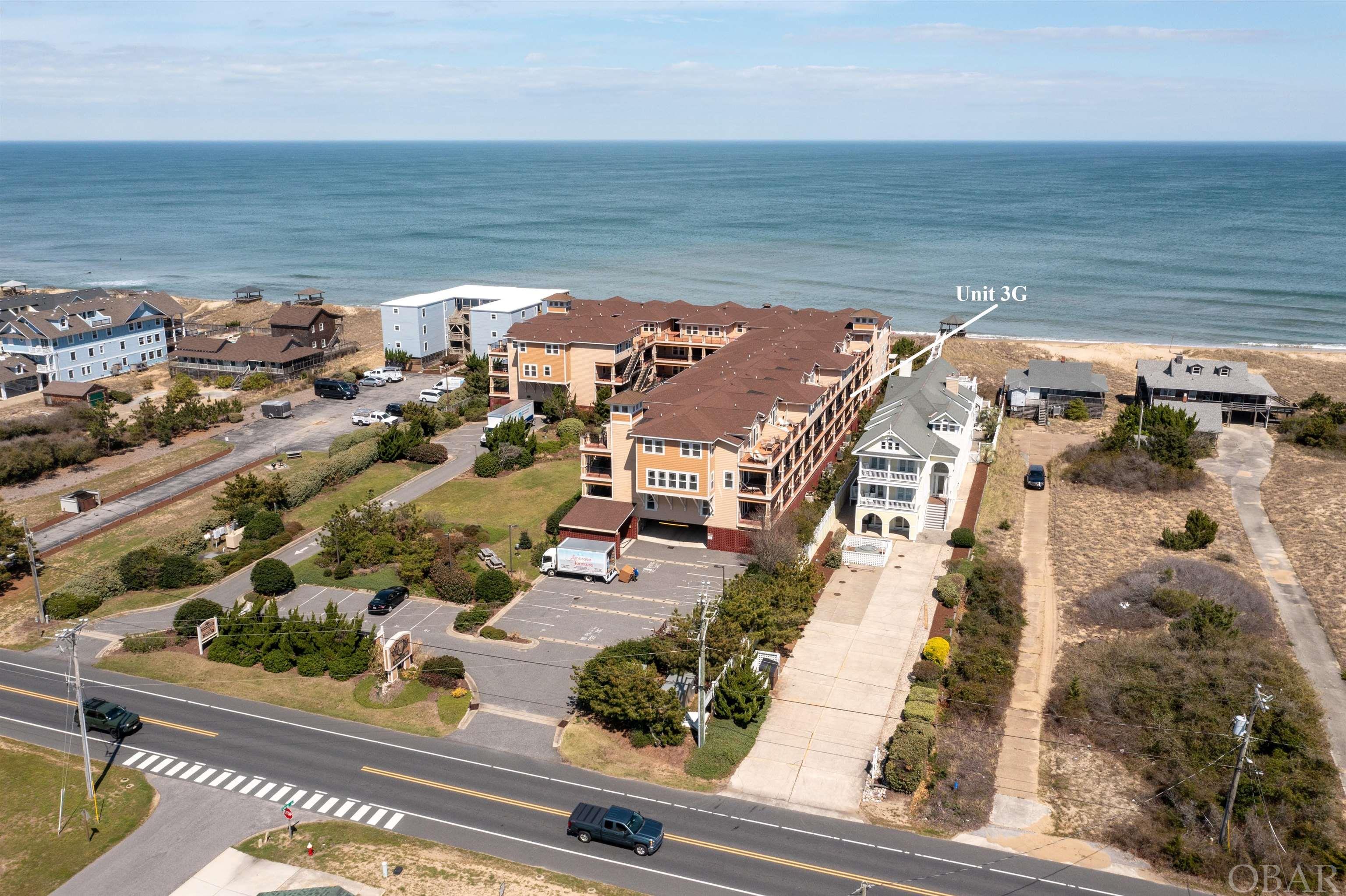 The exquisite Croatan Surf Club Condos embody the coveted Outer Banks lifestyle. Nestled on the oceanfront, these coastal contemporary designed high-end condos offer a plethora of amenities, allowing you to truly savor the Outer Banks experience. This two-level floor plans makes for an ideal living space with  convenience as the covered parking providing a dry entry point, and the near by elevator access ensures that even heavy loads or grandparents can easily reach their destination. Rich mahogany-toned hardwood floors, transition smoothly into light ceramic tiles. Crown molding graces the tall ceilings, and the open floor plan offers a spacious and welcoming atmosphere. A full bath on main level services the kids bedroom and living spaces. The covered deck spaces on each level provide ocean views and plenty of space to relax. There is private deck access from one of the en-suite bedrooms and the living room, make outdoor enjoyment an absolute pleasure. The oversized kitchen has been thoughtfully designed for both style and functionality, with an abundance of coastal white cabinetry, granite countertops, and bar seating. The open concept dining and living areas flow into an outdoor deck overlooking the Atlantic Ocean, bathed in the warm Southern exposure sunlight. The first level features two en-suite bedrooms, complete with tubs and walk-in tiled showers. These units are a testament to quality construction and offer amenities for all your guests. A green space is available for four-legged friends and children to play on non-beach days, and the covered parking area includes a beach lock-up for each owner to store all their beach toys and sandy belongings. The amenities at Croatan Surf Club offer an expansive outdoor curved heated pool, spanning over 80 feet, is complemented by a substantial in-ground hot tub and a kiddie pool with a beach-style entry. Two access points lead to a gazebo with panoramic views of the Atlantic Ocean, providing easy access to one of the finest beach areas in Kill Devil Hills. Additionally, an indoor heated pool, hot tub, and fitness area are open year-round, offering a wonderful escape on rainy days or during the winter. With a solid rental income history, this turnkey unit is an excellent investment opportunity, a perfect primary residence, or a true secondary home. Contact me today for a private tour and a buyer consultation to make your Outer Banks dreams a reality!