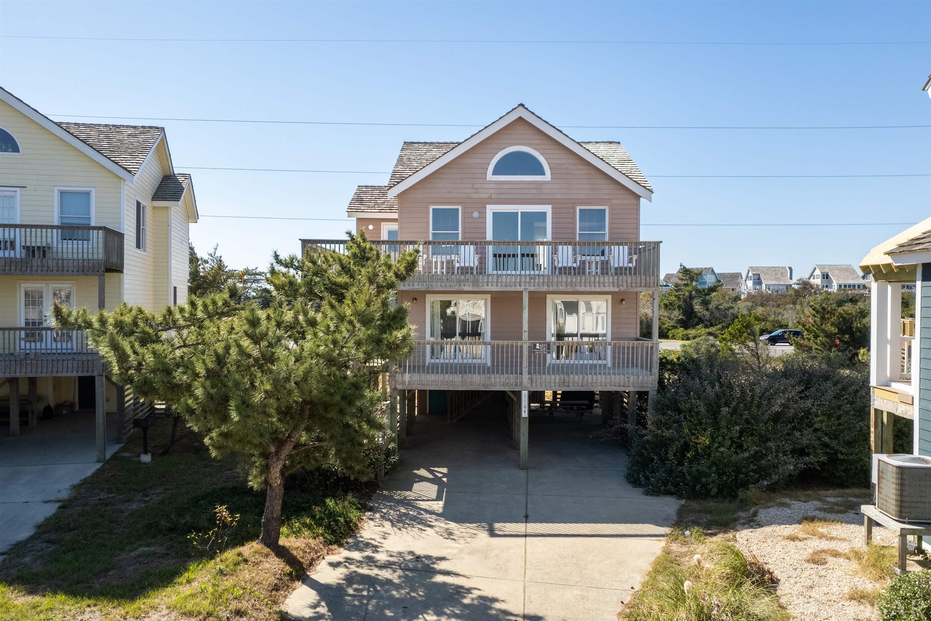 Open House - Sunday, October 29th, 1pm - 3pm.  Nestled in the Village of Nags Head, this investment property or second home offers location value and close proximity to the beach, the Village Beach Club, Nags Head Golf Links and area attractions/shopping.  Designed with an open floorplan, this 4BR, 2.5BA property has a roomy kitchen with eat-on bar, combined living room/dining room, upper level master with ensuite bath, three mid-level guest rooms, full bathroom, utility room and multiple bi-level decks offering ocean views.  Interior features include a cathedral ceiling, gas fireplace with surround, built-in cabinetry, and hardwood floors.  Sold furnished with no exclusions, this property is turn-key ready and ready for its next owners.  The Village at Nags Head Property Owner's Association website is www.vnhpoa.com for details of services and amenities. NEW cedar shake roof, 12/2021. There is a 50-amp hot tub circuit installed and ready for a future hot tub install if buyer desired - per property manager, rental income could be increased 10%-15% with hot tub installation.