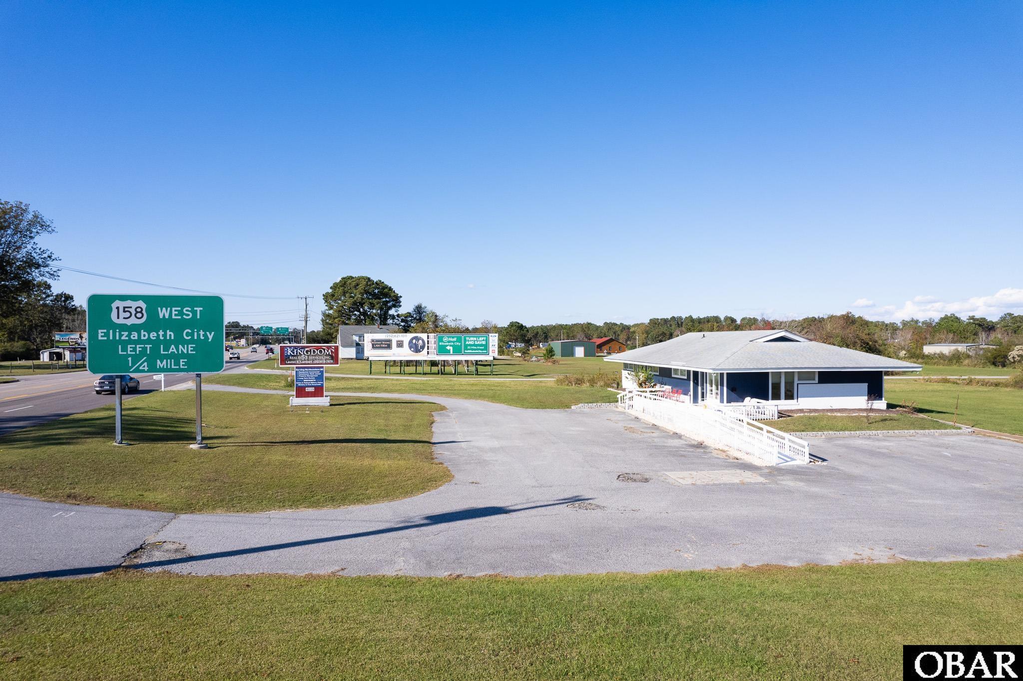 Kingdom Real Estate Services is expanding and moving! That means this prime location is now available! Opportunities are endless, over 2,000 sq. ft. of building space with 0.79 of an acre of land right off Caratoke Highway. Approx. 160 ft of highway frontage off of Caratoke Highway with high traffic count, a circular driveway, and large parking lot. This building is turn key with a large reception area, conference room with private bathroom and copy room, large kitchen, and 6 private offices including one large office suite with its own private bathroom. Handicap accessible features throughout including front wheelchair ramp.