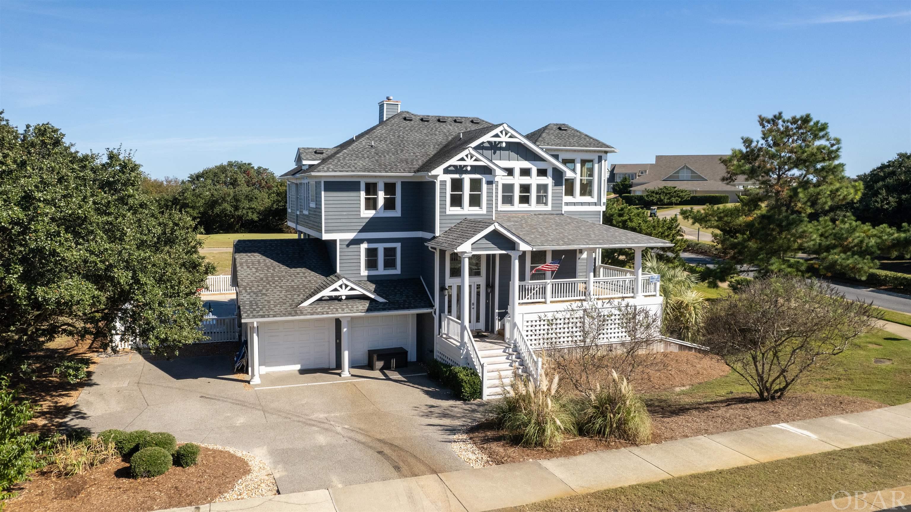 It's a "Beach Par Tee" in the comfort of this 8 bedroom retreat situated on a corner lot in the private gated Currituck Club Resort Community of Corolla, NC! Perched on the 10th tee box with beautiful views of the green and close proximity to the Currituck Sound, clubhouse, pool, grille, fitness center, and seasonal trolley stop for easy access to the beach, this property has all the home and community amenities your heart could desire for a second home, full time residence, or investment opportunity! A large open concept great room w/ custom cabinets, a gas fireplace & oversized windows boasting natural light throughout, gourmet kitchen with granite countertops & dual stainless appliances, island & dining seating, an elevated ship's watch, and half bath. The top floor en suite is well equipped with dual vanities, a soaking tub & standalone shower. On the second floor, four en suites (three with direct deck access) serves as the perfect place to relax and enjoy time spent on the shaded decks or soaking in the hot tub. The first floor features a large game room w/ ping pong, foosball, and media, a half bath, master en suite, two bedrooms, full shared bath, and laundry. This is a great place to unwind after time spent on the beautiful white sandy beaches of Corolla or enjoying the homes extensive outdoor amenities to include a private pool, tiki bar w/ seating & entertainment, outside shower, sun & covered decks.