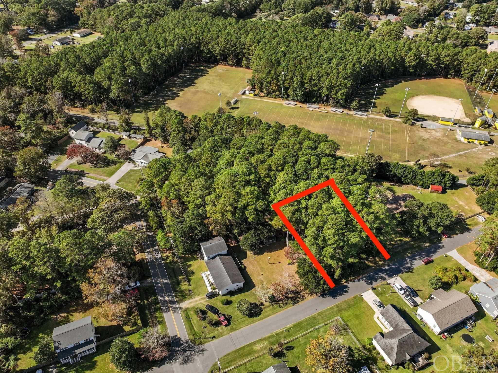 Located in the welcoming island town of Manteo on Roanoke Island, this undeveloped cul-de-sac (X flood zone) lot offers an opportunity for those seeking a piece of land in a picturesque waterfront town. The historic Manteo downtown area is within easy reach and features a marina, boardwalk, Roanoke Festival Park, community events and more.   The true appeal of this property lies in its strategic location near Manteo schools, making the daily school commute straightforward, and situated near local restaurants and shopping, ensuring that everyday essentials and dining options are always a short drive away.  Just minutes from Nags Head, a day at the ocean is just minutes away. With the potential to build your own home on this blank canvas, you have the opportunity to design a residence that perfectly suits your lifestyle. The ability to create a custom home in a residential neighborhood is a rare find, allowing you to shape your living space to meet your unique needs. Embrace the slow and quiet pace of this coastal town while enjoying a cul-de-sac setting with limited through traffic. This lot is a promising opportunity to craft your ideal island home and become a part of the Manteo community.