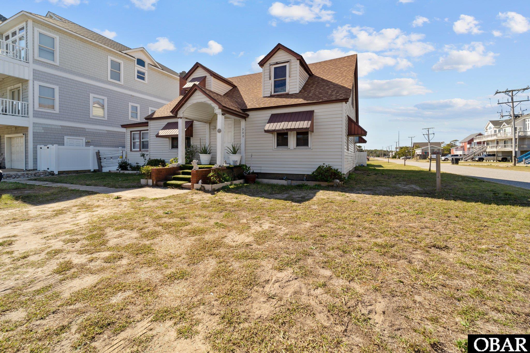Location!!! Location!!! Location!!! Unique South Virginia Dare Trail property with two dwellings and Direct Beach Access. Each unit has a separate water meter, electric meter and septic. Unit A, which is listed as a 4 bedroom/2 bath house faces Virginia Dare Trail. Unit B has approximately 720 square feet of heated living area including 1 bedroom/1 bath with loft facing Oregon Avenue. Both have partial fenced in yards and storage sheds. Great potential with this location, property set up with 2 separate dwellings and commercial zoning. Both units are tenant occupied and require a 24 hour notice to show. Great Investment Potential!!!