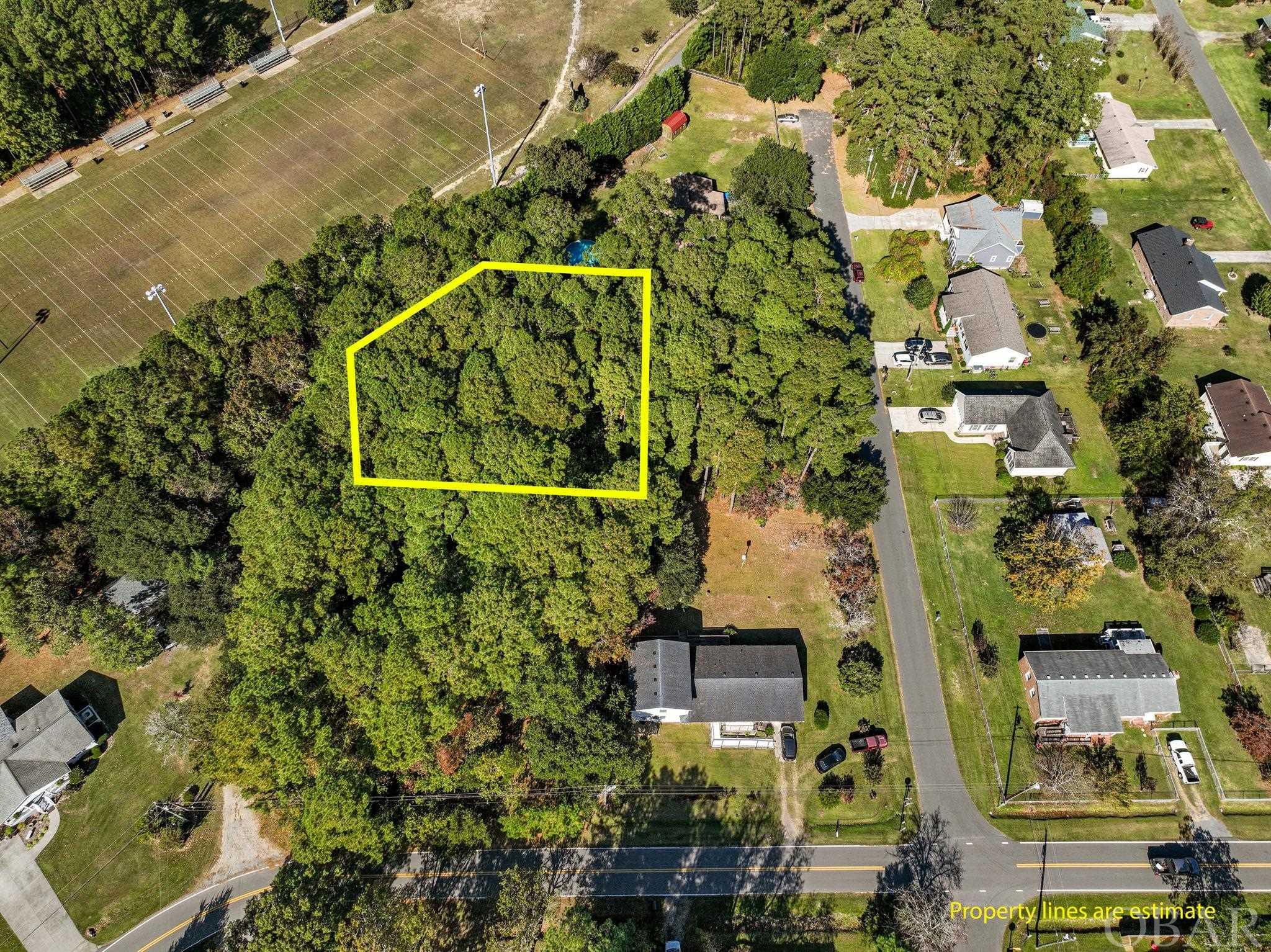 Located in the welcoming island town of Manteo on Roanoke Island, this undeveloped (X flood zone) lot offers an opportunity for those seeking a piece of land in a picturesque waterfront town. The historic Manteo downtown area is within easy reach and features a marina, boardwalk, Roanoke Festival Park, community events and more. The true appeal of this property lies in its strategic location near Manteo schools, making the daily school commute straightforward, and situated near local restaurants and shopping, ensuring that everyday essentials and dining options are always a short drive away. Just minutes from Nags Head, a day at the ocean is just minutes away. With the potential to build your own home on this blank canvas, you have the opportunity to design a residence that perfectly suits your lifestyle. This lot is a promising opportunity to craft your ideal island home and become a part of the Manteo community.