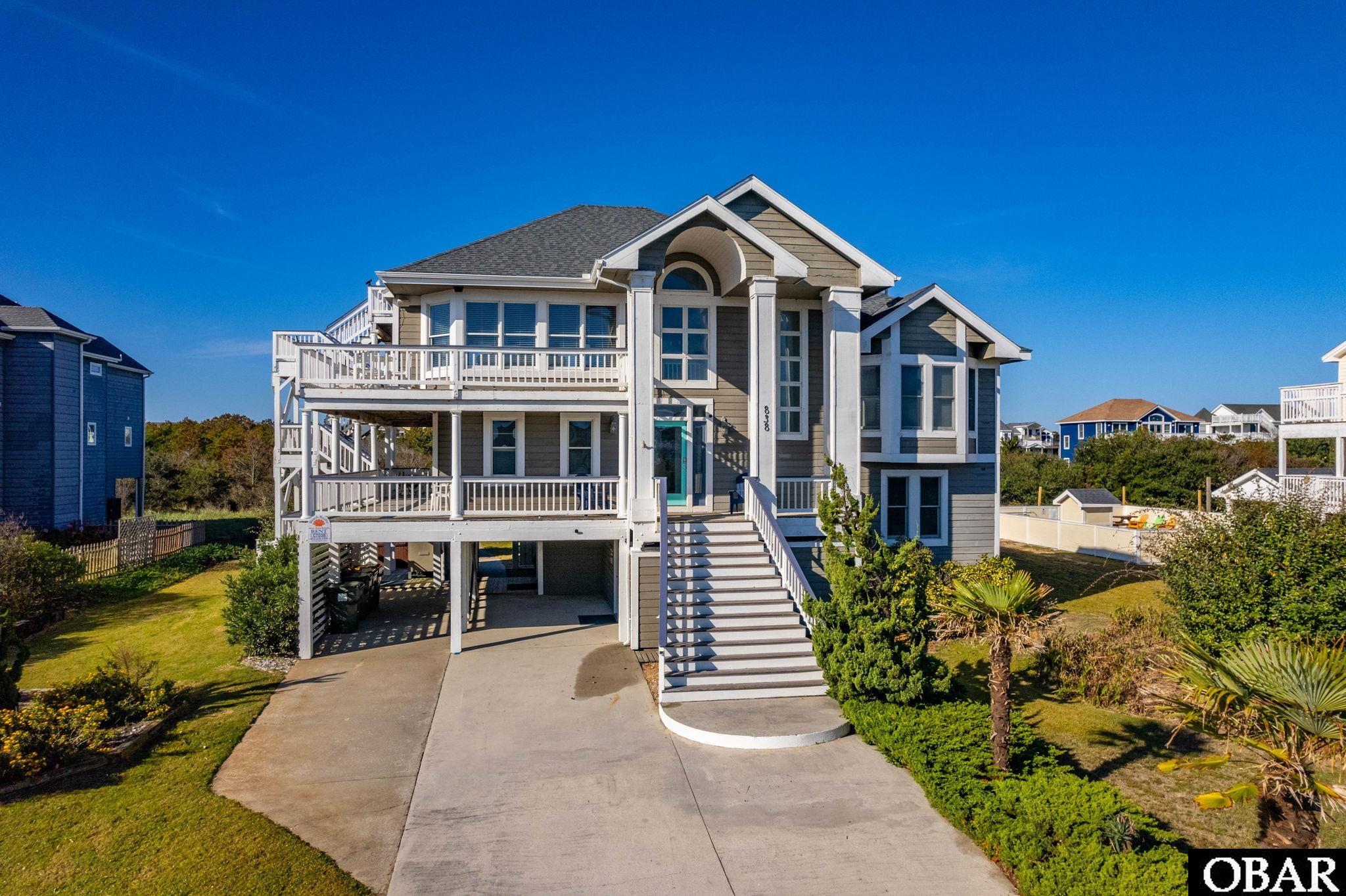 Beautifully appointed home in Corolla.  Home features 6 bedrooms, 4 1/2 baths, open top floor with wood floors, huge living area, dining, kitchen and half bath.  Additional bedrooms are on multiple levels offering good privacy.  Bottom level has rec room/den with kitchenette and full bath.  Wonderful decks to relax and upper deck to take in beautiful ocean views.  Stroll out through the spacious yard  and enjoy the hot tub or out to the large fenced in pool area with pergola and plenty of places to relax. Tons of storage in this home too!  A short walk to the ocean access, close to restaurants, groceries and shopping too!  It's a beauty, check it out!