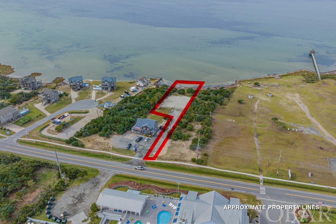 An extraordinary opportunity awaits you in the heart of Waves, North Carolina. This remarkable soundfront lot is a canvas for your coastal dreams, offering an array of features that make it a standout choice. The convenience factor is already in place, with a water meter installed along with the water line up to the construction pad. An elevated 10X12 shed is thoughtfully constructed on-site, providing additional storage space or potential utility. For those with water sports on their minds, this property is a true gem. The sandy beach along the soundfront is nothing short of paradise for kiteboarding enthusiasts. Picture yourself harnessing the wind's power as you glide gracefully over the tranquil waters, creating unforgettable memories against the stunning backdrop of the soundfront. This lot has been thoughtfully prepared for your next steps in construction. With a 4-bedroom septic permit in hand, the septic pad and lot have been meticulously filled and are ready for your architectural vision to come to life. Located in Waves, the heart of the Tri-villages, this property seamlessly blends convenience with coastal charm. Explore the vibrant local community, indulge in the flavors of the Outer Banks, and relish in the laid-back atmosphere that this area is known for. The canvas is yours, awaiting your creative touch. Whether you're envisioning a vacation retreat, an income-generating property, or a year-round coastal haven, this soundfront lot is the perfect starting point. Contact us today to begin the journey of turning this coastal canvas into your dream coastal retreat. The possibilities are as endless as the waves lapping at your doorstep!