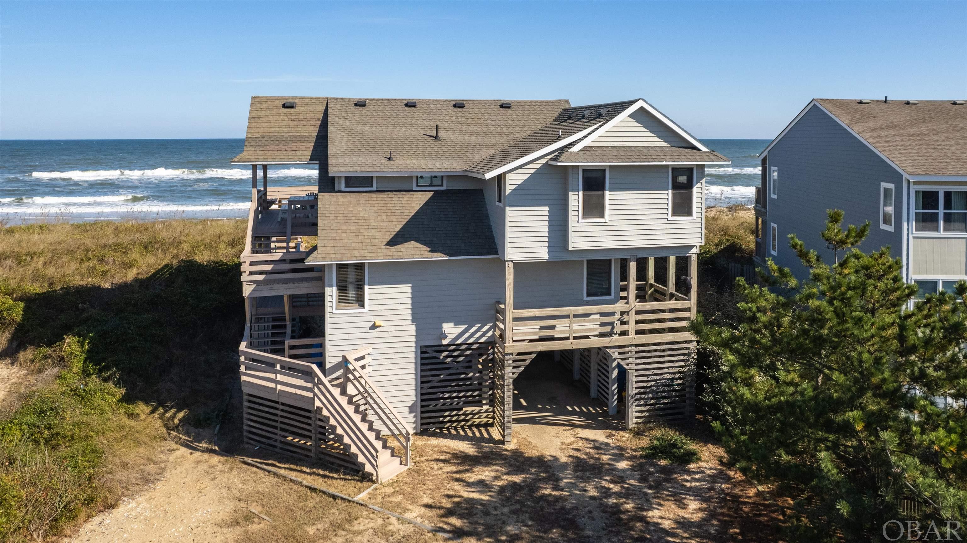 Vintage oceanfront property located on quiet cul-de-sac. 22490 square foot lot with 105 feet of ocean frontage creating many possibilities. Top floor consists of kitchen, living room, dining area, master bedroom, half bathroom and decks galore. Mid-level consists of master bedroom, two additional bedrooms sharing a bathroom, hot tub on outside deck and a media room. Ground floor has utility room, storage area, outside shower and underneath parking. Community amenities include sound front dock for fishing or launching kayaks and numerous nature trails. For additional fee Sanderling community also offers pool, racquet club and gym.