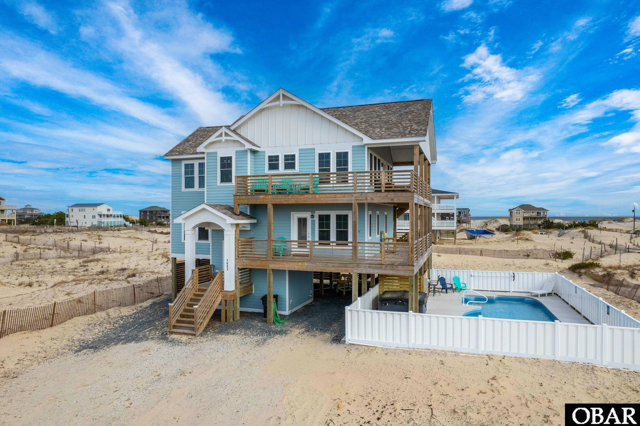 Gorgeous new construction in the 4x4!  What's not to love about this house! 4 Bedrooms, 4.5 baths, with open living/dining/kitchen and bonus mid level living room. Add to that a huge private pool and hot tub and you have the perfect beach house or vacation rental machine!  Located off the main road on the beautful beaches of Corolla, you will only be 3 miles from paved road but out of the hub bub and amongst the wild horses.  Ocean views abound from the generous decking on both top and mid levels. High elevation means x flood zone!