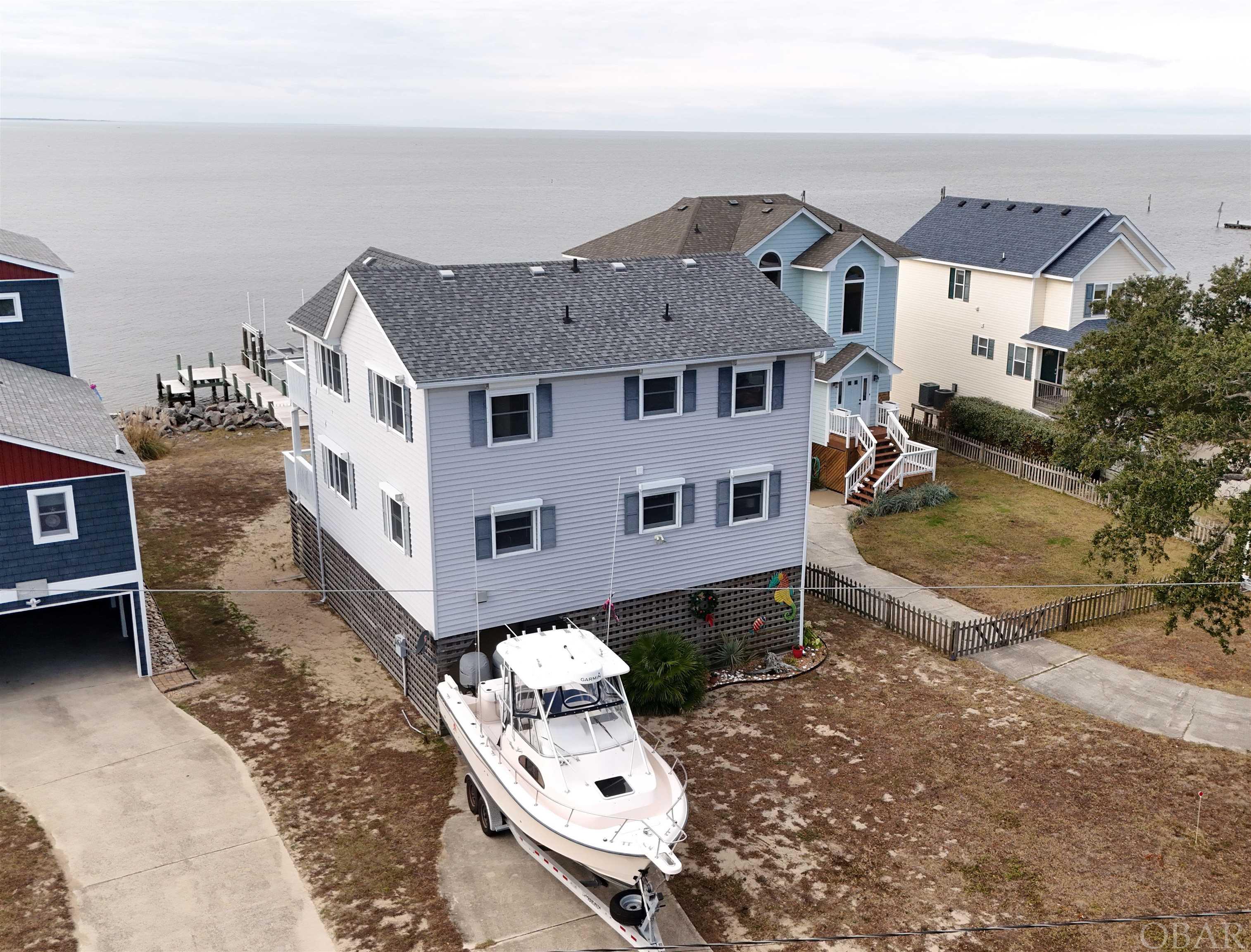 Stunning Sunsets! This home features the Master Bedroom/Bath  on the main floor, additional two bedrooms with Jack and Jill bathroom on the second floor.  Recent updates: 16,000 lb Boat-lift  2023; Roof 2022; Appliances 2018; HVAC 2018;  Hot Water Heater 2018 Water Views from every room with unmatched sunset views of the sound!!