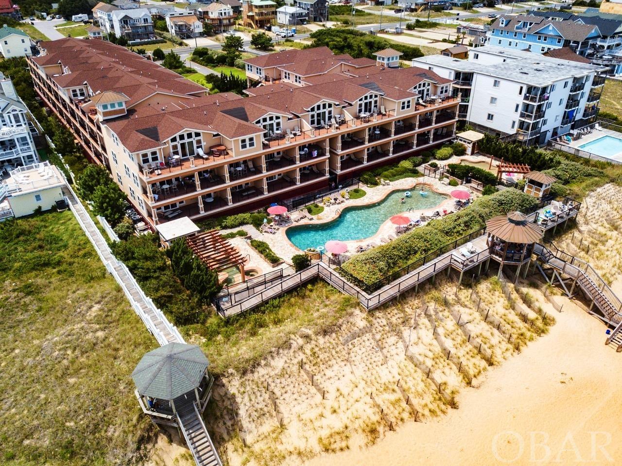 The Croatan Surf Club is a Prestigious Oceanfront Resort located on the Beautiful Beaches of the Outer Banks of North Carolina. This first class community boasts all the amenities one could desire for a fabulous beach vacation. This 3 bedroom/3 bath oceanfront condominium has upgraded appointments throughout including hardwood floors, custom ceramic tile, granite countertops throughout, electric fireplace and yes, the great ocean views from the covered decks overlooking the Atlantic Ocean. Exquisitely furnished for ones immediate enjoyment, either as a place to call home at the beach, for the discriminating vacationer or a great rental investment property. The amenities at the Croatan are as a First Class Resort should be with a tremendous 84' long custom oceanfront pool, separate children's pool w/spray ground, large outdoor hot tub/spa area  and dune-top boardwalks with gazebo which all lead down to the sand and waters of the Atlantic Ocean. Also, indoor amenities include an heated pool with hot tub/spa and fitness room which are open year round. Centrally located and very convenient to many local shops, grocery stores and restaurants. Check out the Croatan Surf Club Today!!!