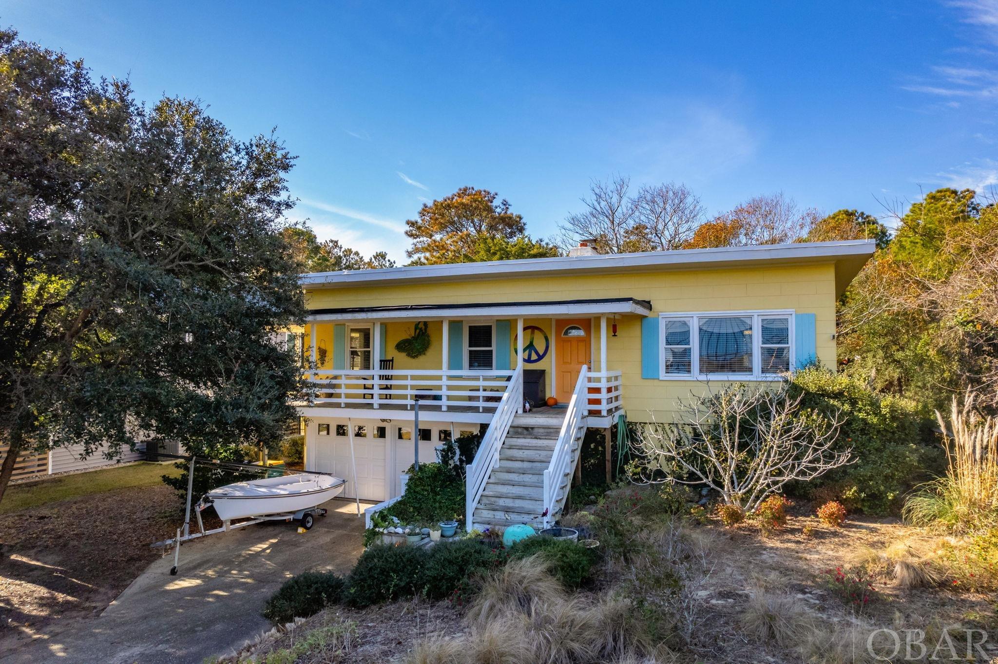 Don’t miss the rare opportunity to own a vintage Southern Shores flat top in a perfect location close to the beach! This beauty from 1960 is airy and light with a fantastic 3/2 floor plan plus incredible basement storage (including a half bath) and a double garage. Don’t worry—its not a tear down! It is a great primary home, second home or vacation rental property.  Inside the home the large windows and skylights bathe the living room area in natural light. The wood paneled walls are epic. The kitchen is designed and outfitted by a chef. There are cool nooks and crannies offering storage and style. The tiled baths are updated with modern touches and timeless materials. The 5 panel cedar doors throughout are gorgeous. The wood burning fireplace is solid and substantial.     The location could not be more ideal.  It is perched at the top of the dune with great elevation. Stroll just 500 yards to the beach directly down Skyline, or you can also take the Ocean View Loop trail to get to a roll over access. The home backs to Chickahauk common space for added privacy. It is steps away from the path connecting to an incredible network of sidewalks and shaded walking paths.  Skyline is a hidden gem in Southern Shores with 6 historic flat tops, no cut through, smaller lot sizes with smaller homes, all within easy walking distance to great restaurants and shopping.  Its super convenient to everything—the beach, airport, “town”, Duck.  Walk, bike or e-bike everywhere you need to go.  Skyline was the first street developed in Southern Shores and today has a nice mix of primary and second homes with the occasional rental.    If you want a home with style and soul, this is your chance!