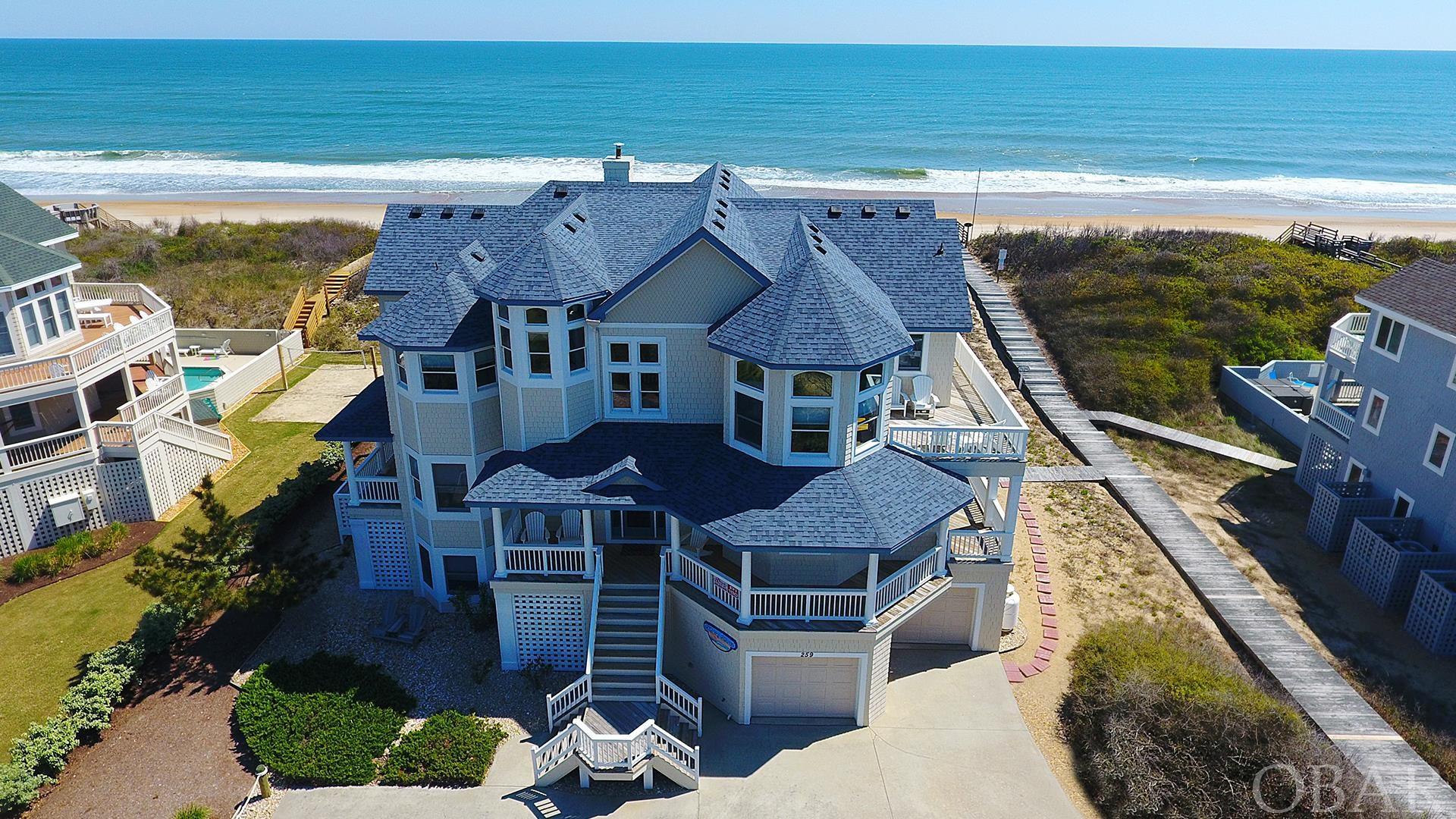 High end, well maintained Oceanfront Home.  Oversized rooms and living area.  Originally built for second home luxury.  Elevated, preferred X Flood Zone location.  100 feet of private dune frontage with unobstructed panoramic ocean views. Private ocean beach access walkway.  7 bedrooms/8.5 baths. 9 Ft ceilings.  2 car garage for easy dry entry and storage.  2 en suite bedrooms ( with water closet) on ground floor with easy access to recreation room and pool area.  Separate full bath for pool entry/exit.  Mid level has 4 bedrooms (3 with water closet) and a sizeable den/entertainment location. Large laundry room with double washer & dryer, additional shelving/storage.  Covered deck access for all.  Top floor has a spacious living area with flow through dining room/adjoining deck with exquisite views of the Currituck Sound.  An open gourmet kitchen with gas cook top and convenient double appliances.  Easy access to sun decks that look out at breathtaking views of the Atlantic sunrise and Currituck sound sunset.  A stone surround gas fireplace will keep you cozy in the cooler winter months.  In addition, there is a peaceful ships watch nook for more privacy.  A large en suite bedroom (separate water closet ) with its own private oceanside deck for personal solitude.  Separate office/sitting area close by.  Comfortable passage to all 3 levels with interior elevator for safety and comfort.