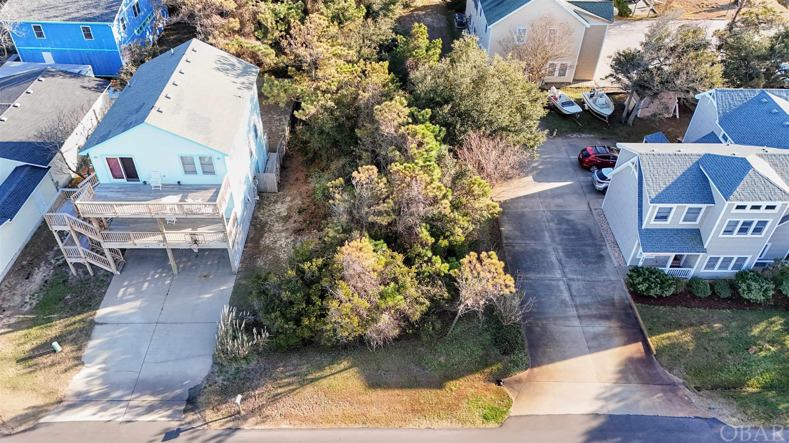 This lot is centrally located to everything that OBX offers!  Walking distance to schools, Dare Co Rec Ct, Dare Co Public Library, KDH Post Office, Baum center, Wright Brothers Monument and airport, bakery, restaurants, beach access, parks and dog park.  With the ability of 65% lot coverage, should be plenty of room for a pool.  There are a mix of vacation rental homes, 2nd homes, and commercial on this street.  You can also build a house and put an ADU (Accessory Dwelling Unit) on back side of lot. Many possibilities of use for this lot.  Although zoned commercial, this lot does not meet the square footage requirements (15,000 sq ft) for a commercial construction.