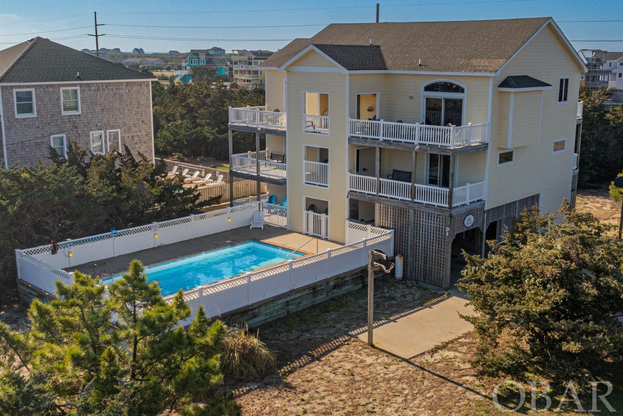 Welcome to "OBX Time," a semi-oceanfront marvel generating an impressive $112,000 in rental income for 2023 and $58,000 already booked for 2024. Nestled in the prestigious Kinnakeet Shores subdivision of Avon, this property is not just a home; it's a lucrative investment. Spanning a grand 4,263 square feet across three levels, "OBX Time" offers a perfect blend of luxury, comfort, and breathtaking ocean views. At the heart of this home is its enviable location, with easy beach access and a balance of privacy and open vistas. The top floor serves as a family and entertainment sanctuary, featuring an open concept family room with vaulted ceilings, a spacious dining area, and a gourmet kitchen. This chef’s dream is equipped with granite countertops, stainless steel appliances, and a sleek countertop bar. Each of the six bedrooms is a private retreat, boasting its own en-suite bathroom. Select rooms offer captivating ocean views and direct deck access, providing serene spots for relaxation. The lower level is a haven for fun, featuring a game room with a pool table and wet bar, alongside a welcoming outdoor swimming pool. Accessibility is thoughtfully addressed, with an elevator servicing all floors and a ramp in the covered carport. The outdoor spaces impress with multiple decks, showcasing stunning views ideal for unwinding or entertaining. Living in Avon, the heart of Hatteras Island, offers a unique lifestyle. This charming community combines essential amenities with the natural beauty of unspoiled beaches, ensuring a perfect balance of convenience and tranquility. Proximity to a grocery store, restaurants, a medical center, and attractions like a fishing pier, spa, and mini-golf course enhances the appeal. "OBX Time" is more than a house; it's a promise of an unparalleled coastal living experience. Ideal as a family getaway, a lucrative rental investment, or a personal sanctuary, this property invites you to embrace the best of Outer Banks living. Discover the joy and luxury of beachfront living at "OBX Time."