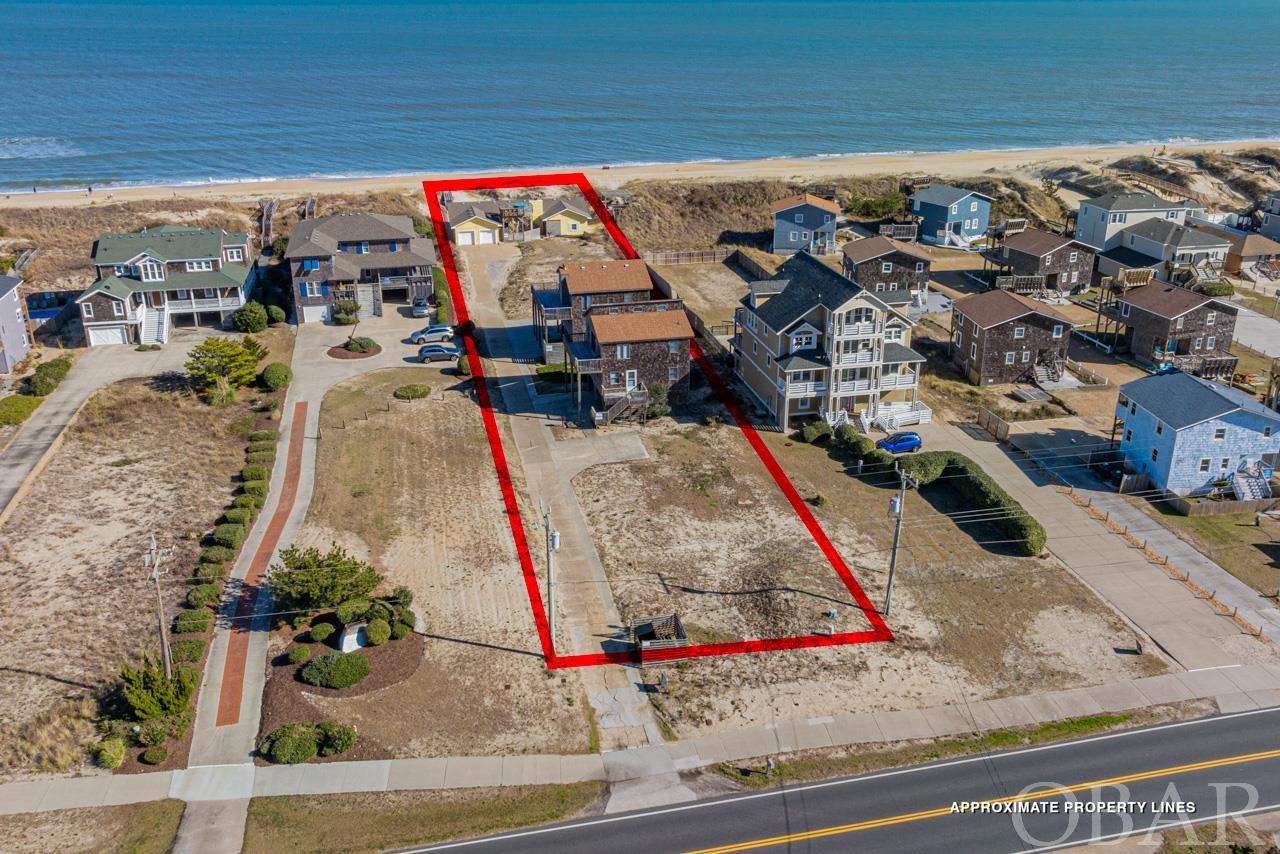 Nestled in the highly sought-after area of South Nags Head, this extraordinary 32,500 square foot oceanfront parcel represents a unique opportunity. Currently, the property boasts three well-maintained single-family rental homes, collectively bringing in an impressive $140,000 in annual rental income. These include a classic 5-bedroom, 2-bathroom oceanfront cottage with direct beach access, a rooftop sundeck, and a private hot tub; a traditional 5-bedroom semi-oceanfront home just a short 150-foot stroll to the beach; and a contemporary 4-bedroom, 2.5-bathroom home equipped with a game room, only two lots back from the oceanfront. Each home offers magnificent views and a taste of the idyllic Outer Banks lifestyle. However, the true value of this offering lies in its unparalleled potential. Given its sizable expanse and prime location, this parcel presents a once-in-a-lifetime chance for the discerning buyer to envision and create a magnificent beachfront estate. The option to remove the existing structures and build anew opens the door to endless possibilities, tailor-made to meet the most exclusive tastes and standards. This property's allure is further enhanced by its rarity in the current market, where oceanfront land in the area is scarce. Priced close to the land value alone, it stands as an exceptional opportunity for investment or for crafting a personal coastal sanctuary. Located a short drive from local shopping, water sports, Jennette’s Pier, and historical sites, the property allows for the enjoyment of both stunning Carolina sunrises and sunsets, thanks to its east and west water vistas. South Nags Head, stretching down to Mile Post 25 and adjacent to the Pea Island Wildlife Refuge, is known for its serene setting and natural beauty. Close to the Cape Hatteras National Seashore, home to the famous bird sanctuary and Pea Island reserve, this area offers a tranquil escape from the hustle and bustle, with less light pollution and a more authentic, old-school OBX experience. This is more than just a property; it’s an opportunity to own a piece of the Outer Banks’ charm, a canvas awaiting a vision, in one of the most coveted locations on the coast.