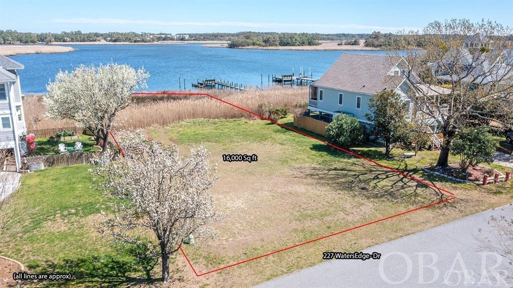 One of the Outer Banks Best Kept Secrets...Waters Edge is located on Little Colington Island in Kill Devil Hills, NC. The community has 80 homesites, a swimming pool and marina with boat slip for each owner. This particular lot is a cleared level lot located towards the end of the single road that goes in this development. At the end of this road is the marina and community pool. Add your own personal dock/gazebo in your back yard for some added outdoor enjoyment. This lot is secluded and peaceful in a development with a simple property plan that gives a great neighborhood feeling for the second home or primary home you've been looking for.