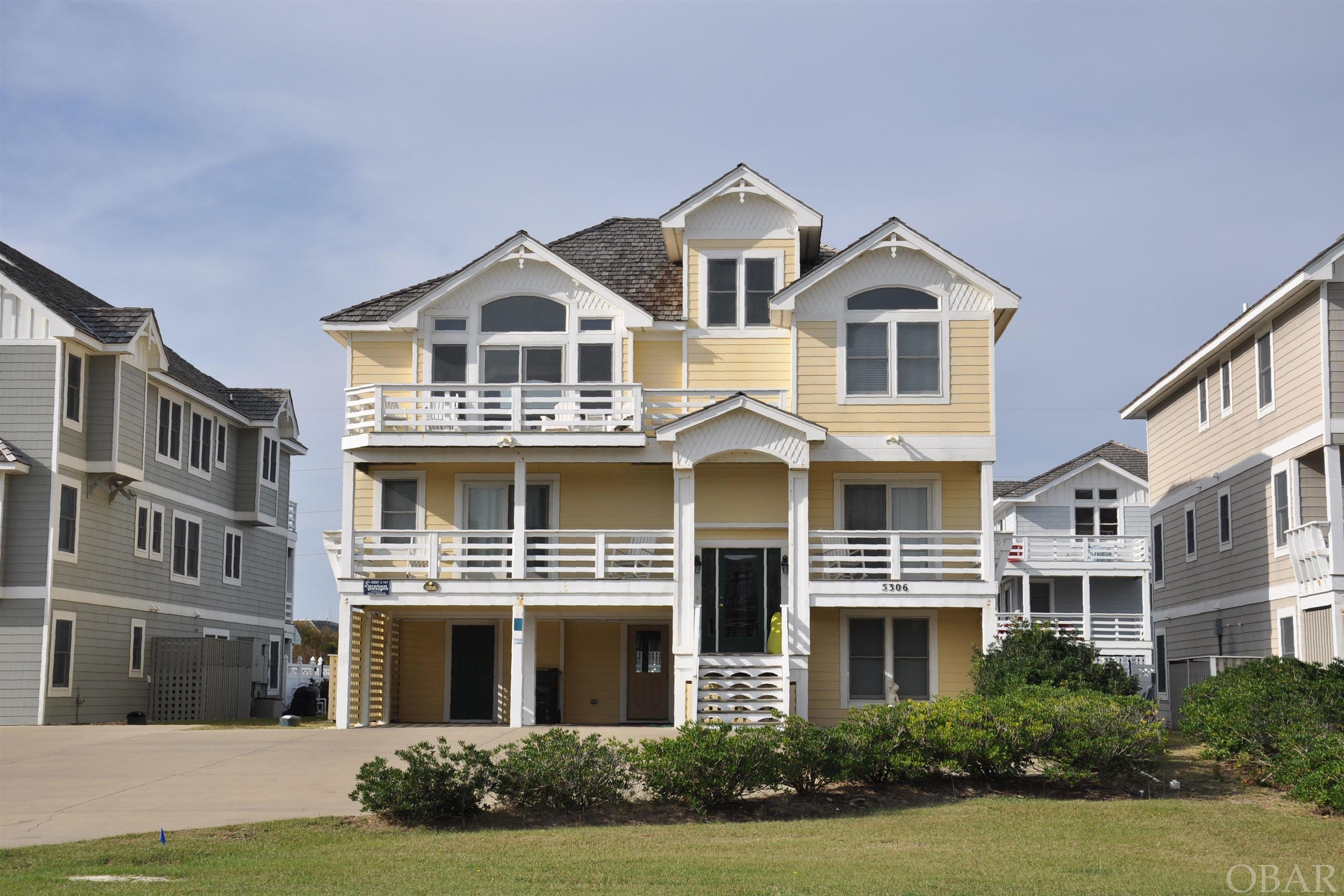 This stunning semi-oceanfront residence boasts an expansive layout, featuring eight bedrooms and seven and a half bathrooms. Its prime location in the heart of the Village of Nags Head provides convenient access to VNH private beach access and two Sound front parks with kayak access.  The Nags Head Golf Links and VNH Oceanfront Pool, tennis, oceanfront clubhouse are all within walking distance and available at additional costs.  Within a few miles there are three piers, Jockeys Ridge, Nags Head Woods, shopping and plenty of fantastic restaurants.  This coastal home offers a well-designed floor plan that ensures a comfortable stay for everyone. The upper level features an open design, perfect for entertaining large groups. The spacious kitchen is fully equipped and appointed with granite countertops. Adjacent to the kitchen, you will find an expansive dining area with two large dining tables, flanked by a comfortable living area offering ocean views. The home also boasts large decks both at the front and back, perfect for enjoying the outdoors.  For added convenience, an ELEVATOR is available to take you down to ground level. Here, you will discover a spacious game room complete with a slate pool table, full-sized fridge, wet bar, and an ice machine pub tables & chairs. Step outside, and you will find an oasis with a private swimming pool, a hot tub, and a tiki bar.   The home includes eight bedrooms, a reading room, and plenty of space to accommodate guests comfortably.   Being handicap accessible makes for easier access for many.  Sun Realty annual projection of $168,000 in owner income!!!