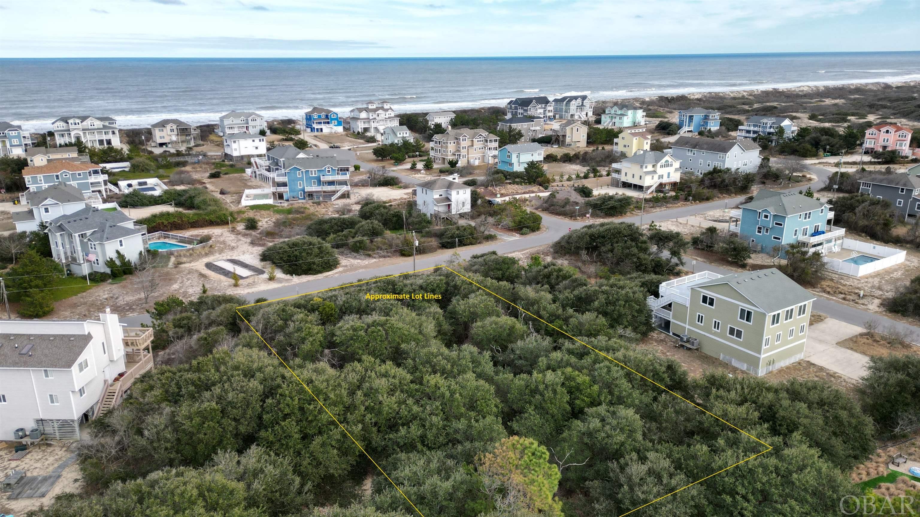 Ideally situated between The Currituck Club golf course and a beautiful wide beach in Corolla, this is one of very few remaining undeveloped oceanside lots in the Ocean Sands South community.  Located on a cul-de-sac with a boardwalk to community beach access at the end, this lot lays well and with a 3-story home may offer golf and ocean views from the top level.  Pick from two different boardwalks that lead you to the beach over a strong sand dune protecting this section of Ocean Sands (Breakers Arch and Ocean Way) - either route is just a 3 minute walk from this lot to the beach.  This lot is unique because it offers more than 1/2 acre of undeveloped land just steps to the ocean - plenty of room to build that dream beach house or investment property!  Over half an acre, X flood zone, potential ocean views and ideally situated in Corolla NC - just minutes away from the wild horses of Carova, the Whalehead Club, the Rees Jones golf course at The Currituck Club and so much more!