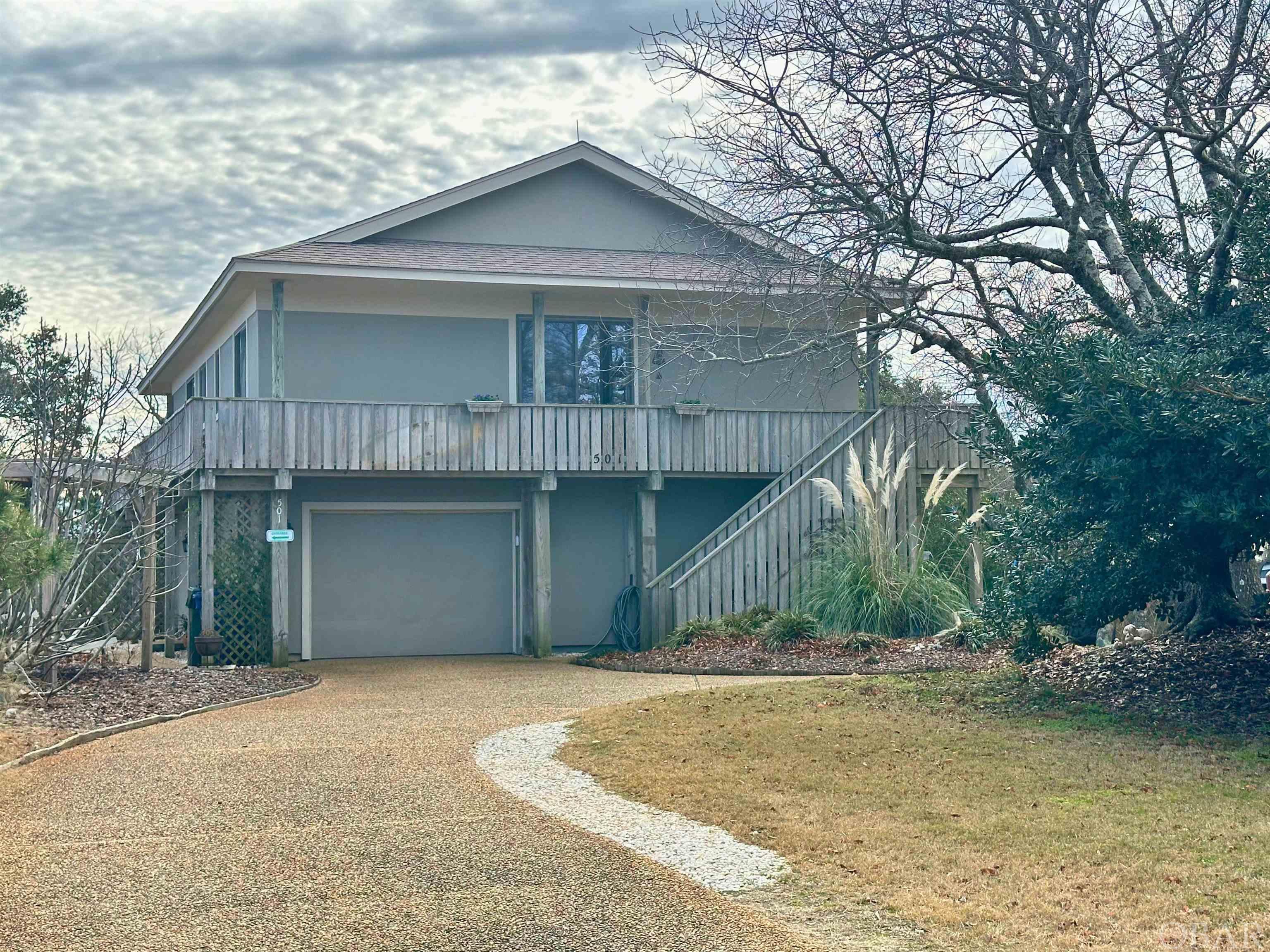 Located in a prime Nags Head Waterfront community. This High and Dry Elevation brings gorgeous sunset views over the water and the Roanoke Sound from the large covered porch. This 3 Bedroom 2.5 Bath home has an additional flex space room that could be used as a home office, exercise room, artist studio, music room, or playroom. There is a large 12x5 pantry located on the main level as well. The primary suite with huge jetted tub is located on the 1st Floor. As well as the Kitchen and Great Room. The remaining bedrooms, flex room, and full bath are located on the ground level. This home boasts with energy efficiency with a Geo-Thermal HVAC system to heat and cool. Along with Propane Water Heater, Range, and the firelogs The 36x10 covered porch is a great place to enjoy the sea breezes and just relax. The 15x20 garage provides a dry entry on those coastal rainy days. Plus the attic is fully heated and cooled to preserve your stored items. Recent Improvements include water heater, flooring, roofing, kitchen appliances and countertops, exterior paint, entry door with storm door and several sliding glass door panels! Has been used lovingly as a primary home, but was previously in a rental program and was successful. Other expense listed is for propane gas. Polybutelyne piping is still present in house. Where new fixtures have been installed new pex piping is in place.