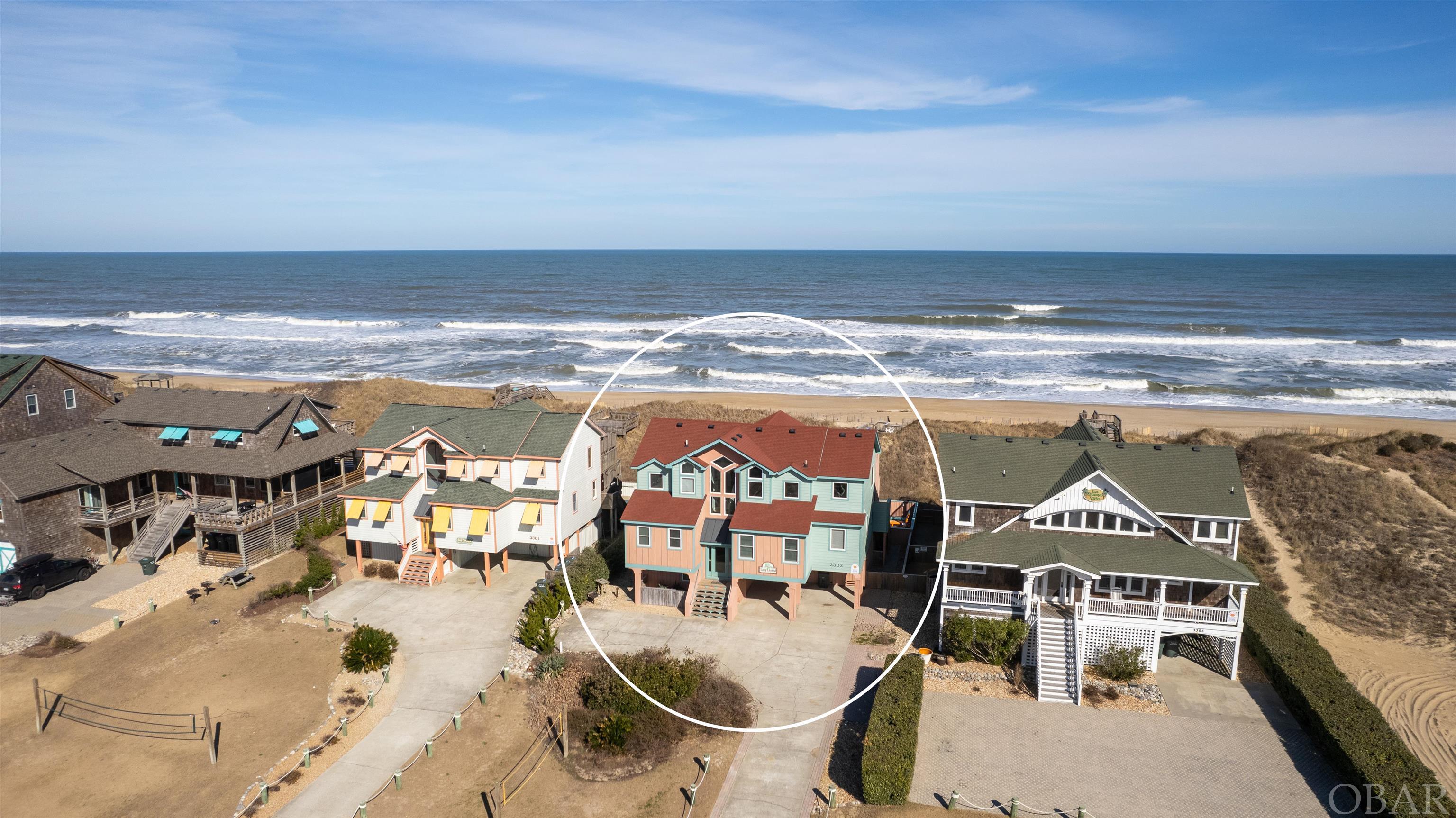 RENOVATED with incredible Ocean Views.  Boasting a private beach access and dune top deck, heated 14x24 pool, 6 person hot tub, 6 primary bedrooms w/ en suite baths (8 per tax records, but actually 9 bedrooms total!), new outdoor fire pit, volleyball, game room, 11 smart tv's, and endless ocean views from almost every room, it is no wonder renters love the 'Lazy Lizard'!  A 9.3% Gross Rental Return based on OWNER gross rentals (not advertised rentals), this is a turn key Oceanfront investment opportunity!  Recent Upgrades include new LVT flooring, new furniture and decor, new interior paint, new pool liner, and so much more ... see complete list in associated docs.  The top level is a show stopper with a wall of Ocean View windows capturing waterfront vistas as far as the eye can see!  Entertaining is a breeze in this grande space with shiplap wall accents, tons of seating, and a gas fireplace.  You will also find a King primary bedroom and powder room on this level.  The mid level features 5 additional King bedrooms all with private en-suite baths along with a twin bedroom (BR #7), all decorated with a coastal feel including local art!  The ground level offers a large rec room with pool table, foosball, as well as a King bedroom (BR #8), bunk room (BR #9), full hallway bathroom, and access to the private pool and oceanside outdoor area.  LOCATION, LOCATION, LOCATION ... MP 11.5 and close to several Outer Banks classics including Tortuga's Lie, Bonnett Street beach access, Dowdy Park, Lucky 12 Tavern, the Nags Head Pier, Surfin' Spoon, and Jockey's Ridge!