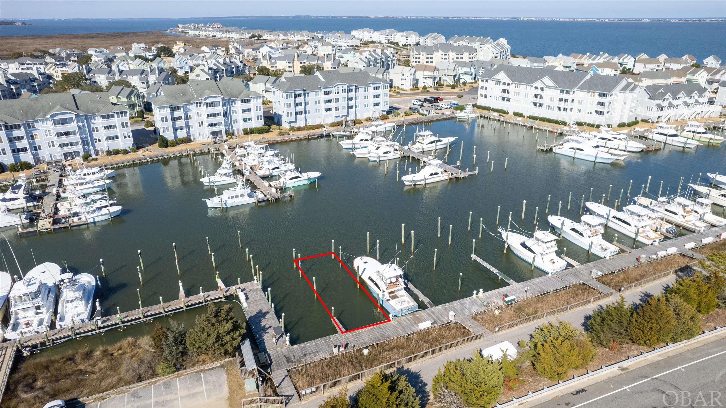 Located on G Dock, this 75FT x 23W boat slip has location value with easy sound access and parking.  Pirate's Cove Marina is a protected, deep water, full service marina with 195 slips and a charter fleet of sport fish boats for offshore, nearshore and inlet fishing.  Pirate's Cove Marina is one of the largest world-class marinas on the East Coast with a high level of experienced charter sport fishing captains and crew. Pirate's Cove Marina offers: a fuel dock for non-ethanol gas and diesel, slips with in-slip fueling, private fish cleaning houses, showers, Ship's Store for light provisioning, an on-site full-service restaurant and Tiki Bar, and annual fishing tournaments.  Pirate's Cove Marina is approximately eight miles inside and north of Oregon Inlet via a deepwater, well-marked channel. The fixed bridge clearance of the Manteo/Nags Head causeway is 65 feet at mean high tide.