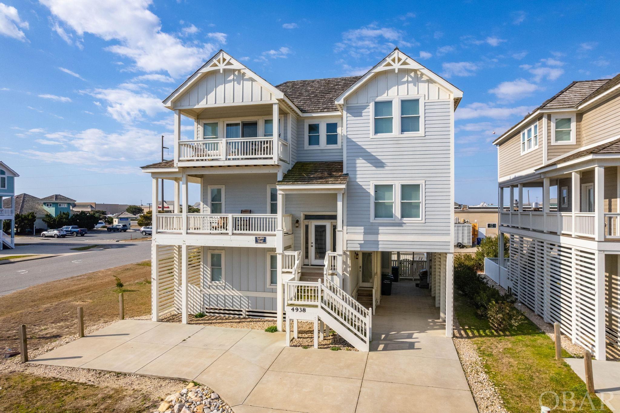 If you are looking for an upscale vacation rental investment property, “Sailfish Station” will have you hooked.  This is a 6 bedroom, 6.5 bath home located in the Moongate community of Village at Nags Head.  With over 3400 square feet, this quality built vacation property offers ocean views, a reverse floor plan, elevator, theater room, multiple en suite bedrooms, game room, private pool and more. The spacious top floor features cathedral ceilings, ocean views from the family room and its east sundeck, reclaimed pine floors, and an open floor plan.  The kitchen is stylish with white cabinetry, stainless steel appliances, a wine cooler, and granite countertops.   A large center island serves as a convenient prep area or as additional seating.  The adjacent dining space can be configured for a large or small group offering just the versatility guests need. The upper level also features a media room where the gang can gather for a movie before heading off to the first of the 6 comfortable bedrooms.  On this level is a spacious primary bedroom with a private deck and a luxurious en suite bathroom. Plank flooring, a double vanity and a separate custom tiled shower and bath create a true spa-like experience.  This suite even boasts its own washer and dryer.    The elevator will take you down to the mid-level where 4 more generous en suite bedrooms await, each with a well appointed private bath, and 3 with covered deck access.  For convenience, another washer and dryer are here.  And don’t worry about closet space- this property has closets galore! The final bedroom is found on the ground level along with a full bathroom.  The adjoining game room is spacious and features durable tile plank flooring.  A handy granite-topped wet bar and a refrigerator make enjoying a game of pool or a turn at the arcade game all the better without having to run to the kitchen for refreshments.  Outside, a 24x10 private pool and hot tub will do the trick for those who take a break from a day at the beach.  But it’s only a short 160 yards to the crosswalk for a morning beach stroll to watch the sun rise over the ocean or catch the dolphin playing in the surf. “Sailfish Station” is an upscale, quality-built vacation home with comfort and convenience in mind.  The ocean views, thoughtful layout, custom touches and proximity to local restaurants and shopping make this property special.  Located in the heart of Nags Head, owners and guests of this vacation property may enjoy the amenities of Village at Nags Head which include a community shuttle, ocean and sound accesses, Village Beach and Tennis Club, and more.  Reel this one in now!
