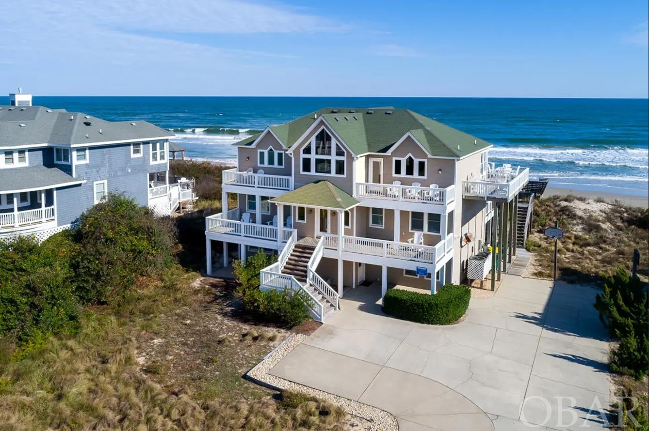 Beautiful well maintained Oceanfront home in Ocean Hill with breathtaking Ocean Views. Ocean Hill is one of the best areas in Corolla, NC. This community provides large oceanfront homesites and wide open beaches making their beaches among the least crowded. Triple Play is a 7 bedroom 7.5 bath home tastefully furnished with updated kitchen and baths, private pool, hot tub and elevator. This oceanfront home is an excellent rental investment property but could make a wonderful second or year round home as well. MANY RECENT UPDATES including NEW ROOF in 2021! Rental income for 2024 is $207,276.50.  Don’t miss this opportunity to own a beautiful oceanfront property in Corolla.