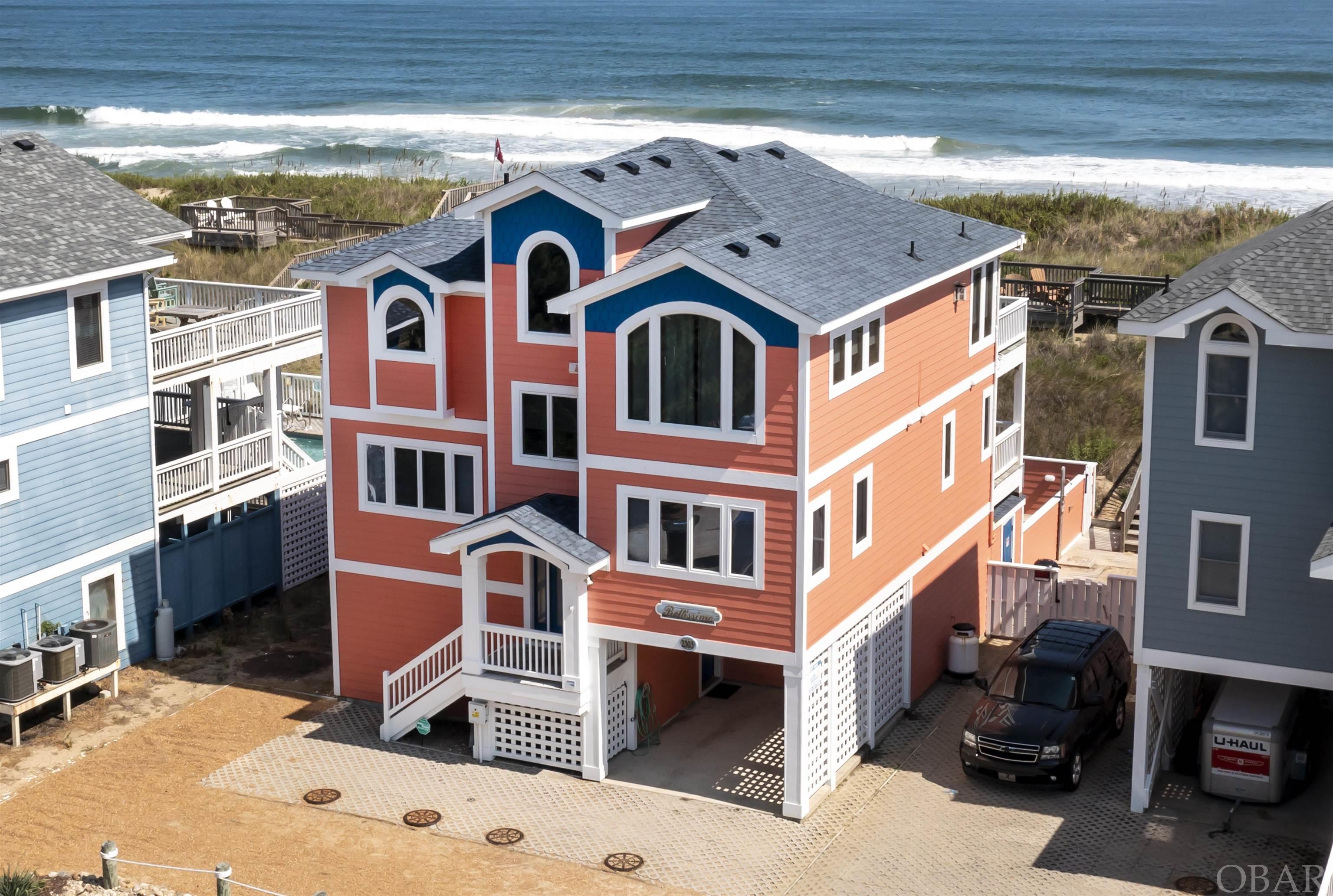 Rare opportunity to own an oceanfront home in an "X" flood zone (no flood insurance required) and in a unique area having a healthy, protective beach that currently does not require beach nourishment or taxed with the special assessments that fund nourishment projects. In addition, it's located on a quiet cul-de-sac offering privacy from the beach road traffic. This 5 Bedroom house offers a reverse floor plan maximizing on the unobstructed panoramic views of the Atlantic Ocean. Your guests will love having their own private bath in any of the 4 en suites. The ground level has a living area with kitchenette and full size refrigerator, full bath and bedroom with 2 sets of bunk beds and en suite. The mid -level has a den/media area, laundry and 3 en suites. The third level has vaulted ceilings, an open living area with kitchen, dining and a separate room for reading, relaxing or a fun game of footsball. It's spacious enough to accommodate large or small groups. You and your guests will appreciate the elevator for handling luggage and getting your groceries to the 3rd floor kitchen. If you enjoy cooking and dining at home, the double dishwashers will make clean up a breeze. Speaking of breeze, there is no shortage of deck space for outside entertaining and enjoying the cool ocean breeze on hot summer nights or soaking up the sun in the private pool or the upper dune deck. Easy access to the beach with a shared boardwalk with the neighbor. Perfect for 2nd home or rental investment. This vacation home has a solid rental history with repeat guests. Within walking distance to many popular restaurants, shops, ice-cream and the Gallery Row art district. This is a one of a kind property because of its unique location and "X" flood zone. Call today for a private tour.