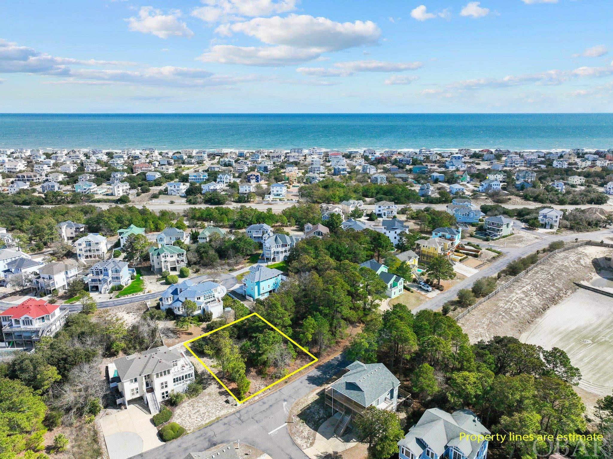 Don't miss out on this prime building site in Monteray Shores! Located in an x flood zone, this gently sloping lot is perfect for your custom-built dream home. Enjoy potential sound views and breathtaking OBX sunsets from your very own deck. Or, build with vacation rental investment or your retirement future in mind. Plus, with shopping, restaurants, and the beach within walking distance, convenience is key. Monteray Shores offers wonderful community amenities such as an outdoor pool, clubhouse with fitness center, tennis and basketball courts, and a playground for the kids.  There is also a convenient boat ramp, sound side pier and overlook.  Now is the time to make your OBX dreams come true.  What are you waiting for?