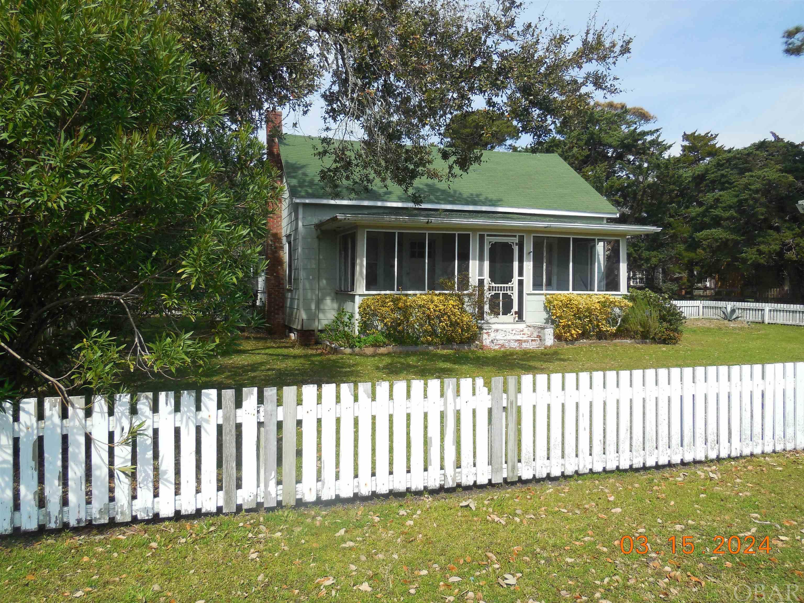 Rebecca and Wallace's is an opportunity to own an oversize parcel in the heart of historic old Ocracoke! 22,806 square feet of yesteryear! Lovely grassed yard with mature pine, live oaks and cedar trees as well as figs! Just relaxing in the yard brings back memories of fishing tales and carvers' dreams. Old buoy's and hand- made shell wind chimes hang from live oaks, a reflection of slower and simpler times. The original home with a white picket fence was built in the early 1900's, faces Lighthouse Road, and is a "blank canvas". The home flooded in Dorian; however, just as other older homes on Ocracoke, it was built to dry out easier after floods. Having no insulation, the water flowed in and out without barriers. The home has been taken to the studs waiting for that special craftsman/carpenter to bring it back to its original splendor. It will take a lot of work, but for the right person it will be a labor of love. In addition to the original home there is a charming vintage studio apartment with a small living, sleeping & kitchen area with luxury plank vinyl flooring, ceiling fan, P-TAC unit, a half bath, outdoor shower and large open deck. Attached to the studio is a shed for tools, beach and fishing equipment. There is enough property in the back of the studio for an additional home. So many opportunities! Property conveys with one water meter and 3 septic permits, currently in process. The listing price reflects the property in its current condition and potential; however, if the original buildings were removed there may be the opportunity for an additional building site. Property is being offered in its current state.