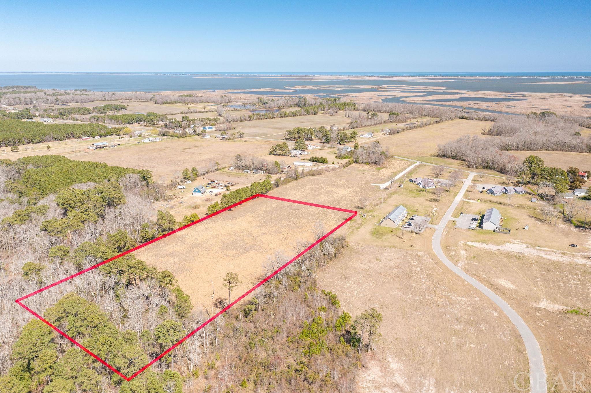 Almost 12 Acres, cleared in Lower Currituck. Looking for a spot to lay a few roots down and let them grow? Look no further. With  acres to spread out, this space has so many possibilities. With no HOA and no HOA fees (or HOA restrictions), you have the freedom to make this property your own private oasis. Centrally located within Currituck yet just a very short drive to the Outer Banks. Grocery shopping is located within miles but you can still enjoy a slower paced lifestyle on the backroads.