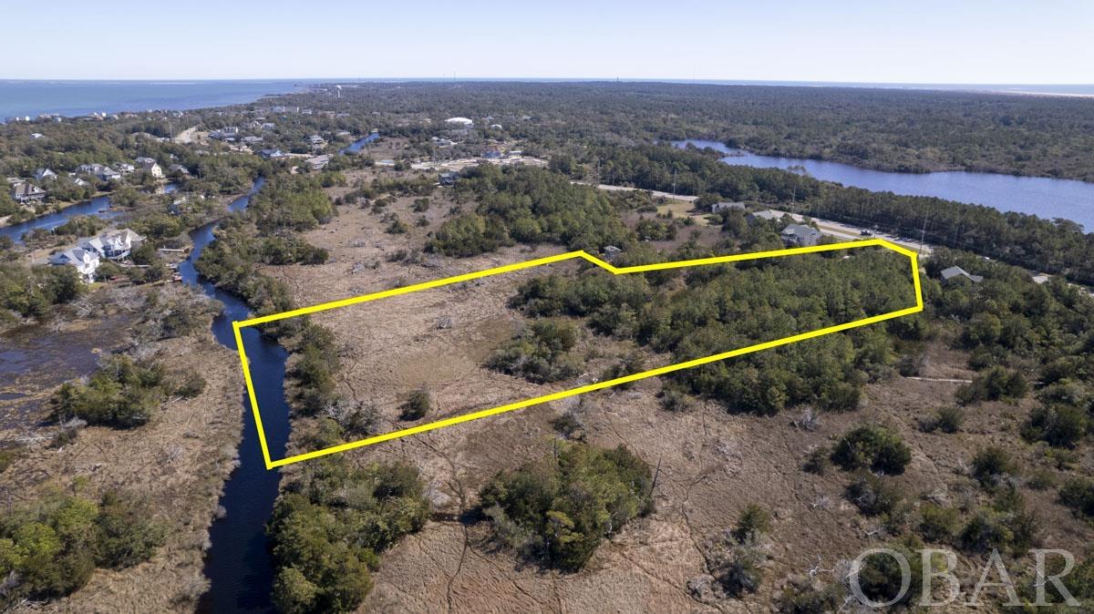 Large wooded lot in Frisco with multiple possible building sites. Design your dream coastal retreat on this private lot, offering beautiful marsh and long-range Sound views. At almost 5 acres, the possibilities are endless. Come see for yourself! New recorded plat in in Associated Docs. GIS will be updated by end of March.