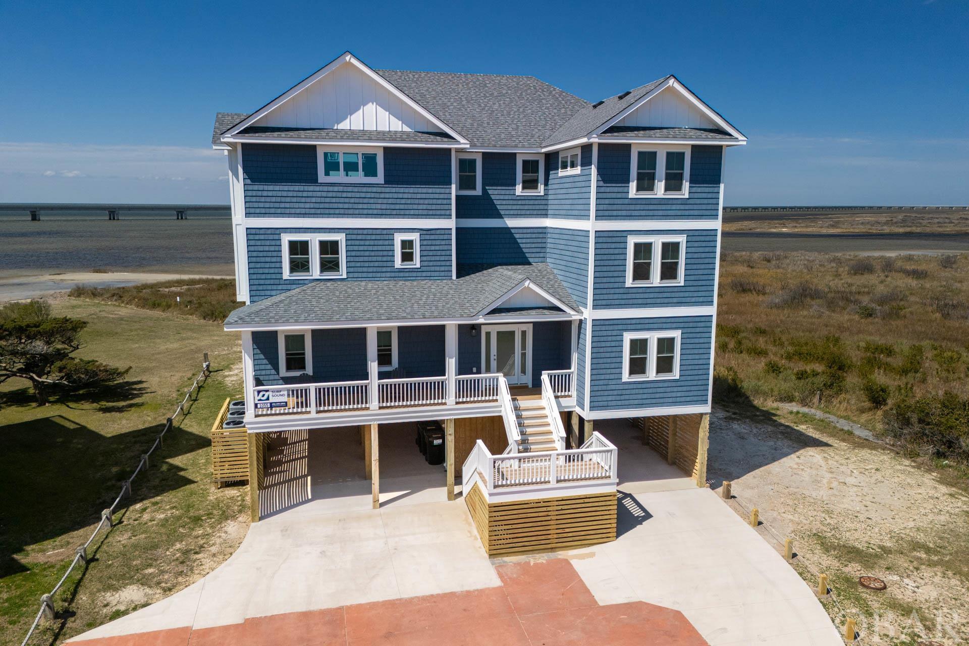 Priceless Views!!  Rare opportunity to own a Luxurious Soundfront Retreat with Panoramic Views!  You can watch the sunrise over the Atlantic and the sunset over the Pamlico sound.  Welcome to your coastal paradise in the serene subdivision of Mirlo Beach in Rodanthe, NC.  Private sandy beach with access to the sound to enjoy all water-sports or just exploring.  Close to the secluded beaches of Mirlo where there is a world class surfing beach and miles of uninhabited beach to enjoy with your family.  This magnificent soundfront home offers a rare and unique opportunity to own a piece of paradise with panoramic 270-degree views of the ocean, sound, and adjacent Pea Island National Wildlife Refuge.  There is a water view from every window.  Situated on a sprawling 28,000 square foot lot, this stunning property boasts 9 bedrooms, 9 full bathrooms, and 2 half baths spread across approximately 5100 square feet of living space.  Each bedroom features its own private bathroom and smart TV, ensuring comfort and convenience for all guests.  Step inside to discover a meticulously designed interior, featuring upgraded bathrooms with beautiful tile showers, luxury vinyl plank flooring throughout and an open concept living area with high vaulted ceilings and expansive water views.  The gourmet kitchen is a chef's dream, complete with quartz counters and backsplash, double refrigerators, double wall oven, stove top, and double dishwashers.  Entertain guests in style with three levels of decks facing the water, a private pool and hot tub, outdoor showers, and a game room equipped with a pool table and wet bar. Movie nights will be unforgettable in the home's theater room, while the nearby community courts offer tennis and pickleball for outdoor enthusiasts.  With its coastal design and abundance of decks and gathering areas, this property is the epitome of luxury beach living.  Built in 2022, this amazing home was built by Sandalwood Construction who is a premier builder with over 40 years experience designing and building fine homes on the Outer Banks.  This property is built to a standard for achieving low maintenance for the homeowner.  The builder combined roof shingles, exterior siding, composite trim, windows, doors and construction techniques that collectively create a product that will stand up to the elements and be a sustainable home for years to come!  The new bridge routes traffic around Mirlo Beach creating a new and improved 'north end' of Rodanthe that will have no through traffic. No more busy streets to cross when you are going to the beach! This is an incredible location for your dream 2nd home or investment home. Enjoy everything that Hatteras Island has to offer such as pristine uncrowded beaches, world class kite boarding and surfing, fishing and amazing local restaurants and fresh seafood.  This home is not your ordinary investment property.  It is a fine home that blends a once in a lifetime location and high quality construction for the most discriminating of buyers.  Don't miss your chance to own this extraordinary soundfront retreat in Rodanthe!