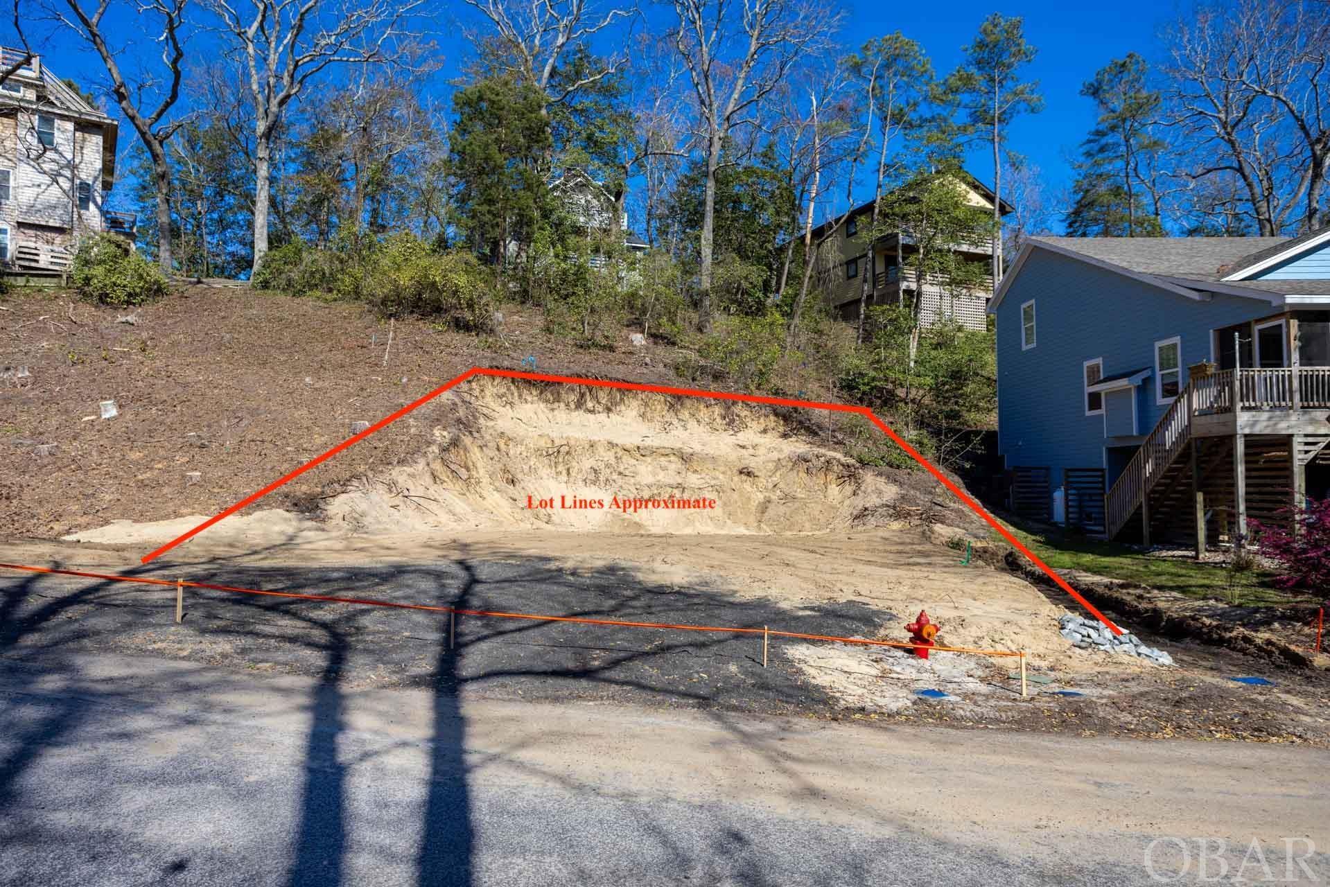 EXCAVATED AND READY-TO-BUILD lot in the sought-after Bay Cliff Community just beyond the Wright Brothers Memorial. This gated soundfront community is a quiet peaceful haven on the Outer Banks. This unique opportunity sits high and dry on an X flood zone area and allows a build with a minimum of 1,600 sqft. Your dreams are limitless as you design and create the space that works best for you and your family. This best-kept secret is in perfect proximity to beach accesses as well as, the tranquility of the Albemarle Sound. This lot facing the west offers the most stunning sunsets imaginable! Picture cotton candy skies while sipping an evening cocktail or cup of coffee off of your front porch. Not only are you close to the beach but so much more! Head to local Seafood markets, restaurants, and bars. Let's talk community! The Baycliff community has everything you need: security with the guard gate, privacy with the lush vegetation, high elevations, and community amenities. The community amenities do not lack! They include a lovely soundfront pool and clubhouse, a gazebo, a fitness center, and a boat ramp with sound access for a minimal fee. Land is precious and will eventually run out on this beautiful island. Don't miss out on this amazing opportunity to build your dream Outer Banks home in the Baycliff community.
