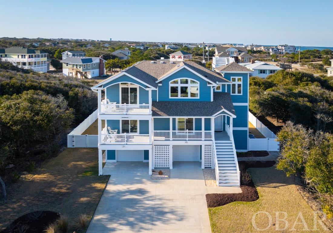 Magnificent seaside home with elevator and ocean views, meticulously crafted by the award-winning Croatan Custom Homes. Turn-key ready, stylishly appointed with fine furnishings & decor. Only four lots from the uncrowded Sea Crest Village beach! Built with maintenance-free living in mind by utilizing the latest in beach environment construction materials. Pella high-impact windows & doors, LP Smart Side trim & siding, whole house generator, spray foam insulation, and Huber Zip system sheathing. Top level is an open floor plan designed for entertaining and showcases the gourmet kitchen with custom motorized window blinds, 48” range & double oven, pantry, wet bar with wine cooler, french door access to the coolest unobstructed-view screened porch, and Sonos speaker system throughout. Top-level Flex Room is currently used as an office but includes sleeper sofa and built-in french door blinds thus quickly converts to fourth bedroom for guests and leads out to covered ocean-view deck. On mid-level you'll find the laundry room with storage/mechanical closet and door to rear covered deck, and three ensuite bedrooms! Primary bedroom has large luxurious bath with soaking tub and walk-in dual glass-walled shower. Outdoor entertainment with hot tub, salt water pool with remote cleaning/filter system, resort landscaping with lighting, soft zoysia lawn, outdoor shower, outdoor sound system, and well pump for yard irrigation. Large garage has EV outlet, full stall-shower bath, Tool Room and air-conditioned Exercise Room in which all equipment conveys! Buried propane tank in east side yard is owned and conveys. Expansive Trex decking on all levels with multiple sitting areas, all vinyl deck railings, vinyl-fenced back yard, raised garden bed, and panoramic views from the crow's nest! THE LIST GOES ON! Check out the Matterport and learn about Croatan Custom Homes at: www.croatancustomhomes.com
