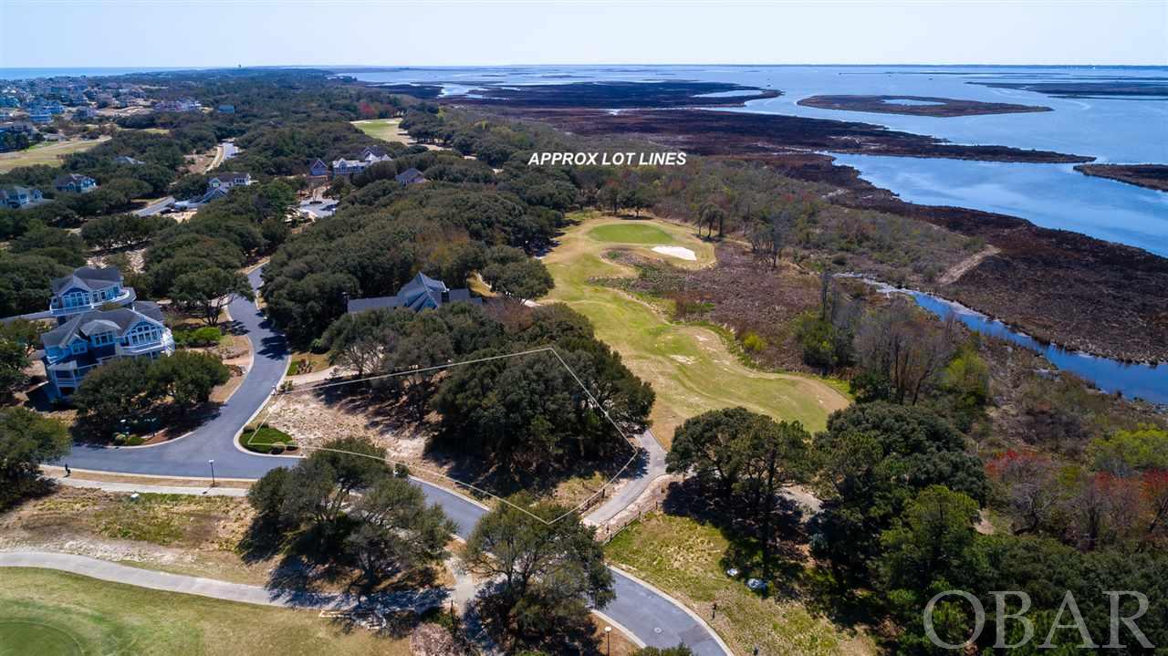 Large, corner soundfront homesite awaiting your dream home to be built in the prestigious gated community of The Currituck Club. A unique opportunity to take in sunset views overlooking the 15th hole and views of the 14th hole as well. Enjoy all the amenities that the Currituck Club has to offer including private beach access with valet trolley service available, a Rees Jones designed 18 hole golf course with driving range, pro shop, and Bistro. Multiple community pools, tennis courts, and a fitness and health center make this community ideal for full time ownership or provide great options for a guests looking for an idyllic rental. Well appointed and  located minutes away from shopping and dining in Corolla. The historical Whalehead Park, Corolla Lighthouse, and the 4-wheel drive beaches are just minutes away!