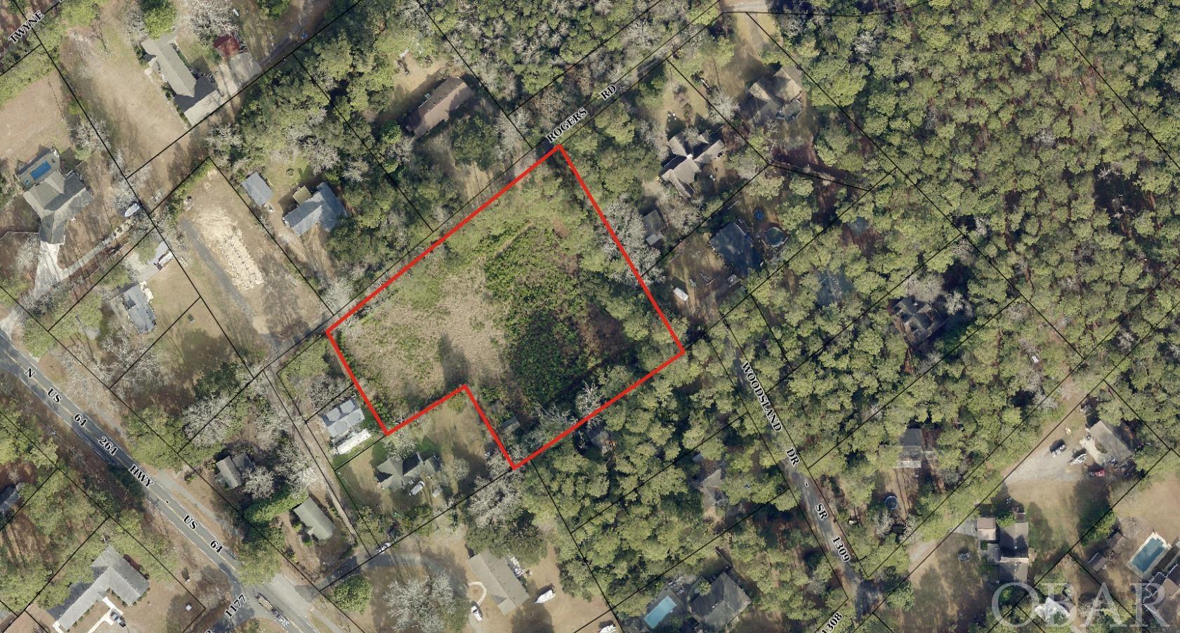 This is an enticing opportunity for anyone looking for a spacious and private lot in  Manteo on Roanoke Island. This parcel has approximately 335 feet of road frontage on Rogers Road and it appears there is a potential to divide the parcel into 3 or 4 lots! Whether you are looking to build a dream home with ample space for equestrian activities or considering investment opportunities through subdivision, this is the one. This is a flat parcel in the "X" flood zone that had previous fill and site work completed. Come check out this opportunity and dream big!