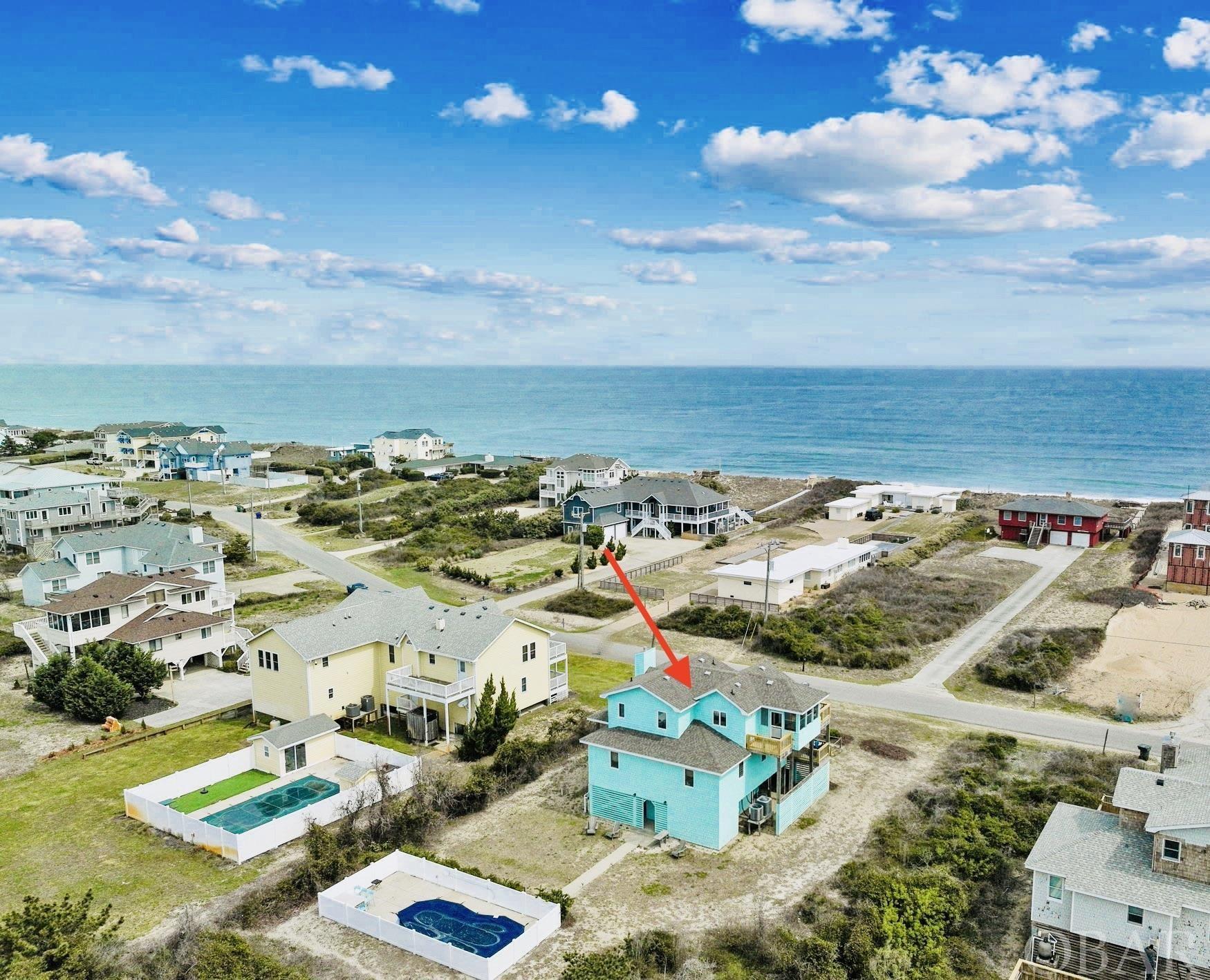 This beautiful well maintained semi-oceanfront home is tucked away on a quiet street, just a few steps away from two separate beach accesses. This sought after Southern Shores location is away from the hustle and bustle, yet only minutes from restaurants, shops, movies, golf and so much more. The upper level of this home features an open concept design with a fully updated kitchen with plenty of bar seating, two dining areas, great room with gas fireplace, vaulted ceilings and direct access to an east facing sun deck and screened-in porch - the perfect place to take in the stunning ocean views. The covered deck below is yet another great spot to enjoy the outdoors and ocean breeze. On this mid-level you will also find a laundry closet, four spacious bedrooms (one en-suite) and an additional full bath. All new LVP flooring and new paint throughout. Dry entry and enclosed storage on ground floor. Outdoor shower, fish cleaning station, outdoor pool with large sundeck for relaxing. Lots of parking! House is being sold fully furnished.