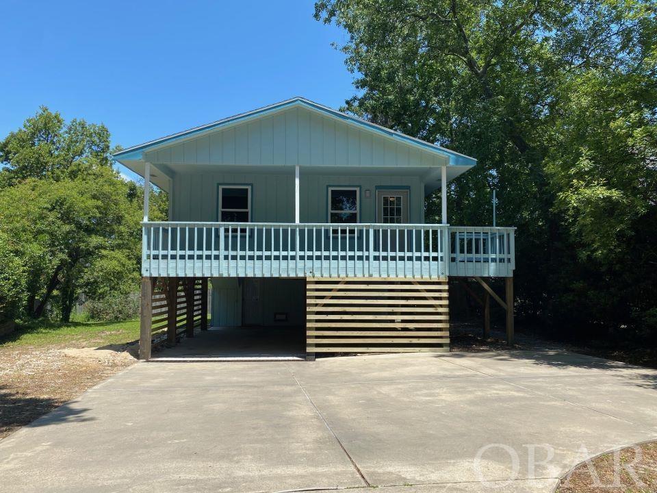 LOOK what is Back on the Market - LOCATION - LOCATION -PRIVATE, QUIET and MOVE-IN Ready! Located on a cul-de-sac on a LARGE .26 acres lot close Colington Harbour main entrance. This updated 3 Bedroom,1.5 Bath Beach Box features a NEW roof, 3 NEW pilings, NEW paint and NEW floors, remodeled bathrooms and updated appliances. Upstairs you have an open kitchen and living area with a full bathroom in the hallway, master bedroom with half bath and another bedroom. An office area leads to the downstairs area which includes another bedroom and bonus room with laundry area. A huge backyard offers room for a huge garden, backyard play or possible pool. Ready for you to create your Outer Banks memories. Additional improvements include: new corner/sun deck, concrete driveway, landscaping throughout. Colington Harbour offers a large outdoor Community pool and tennis courts for an additional fee. You will adore this home - Take a look today!