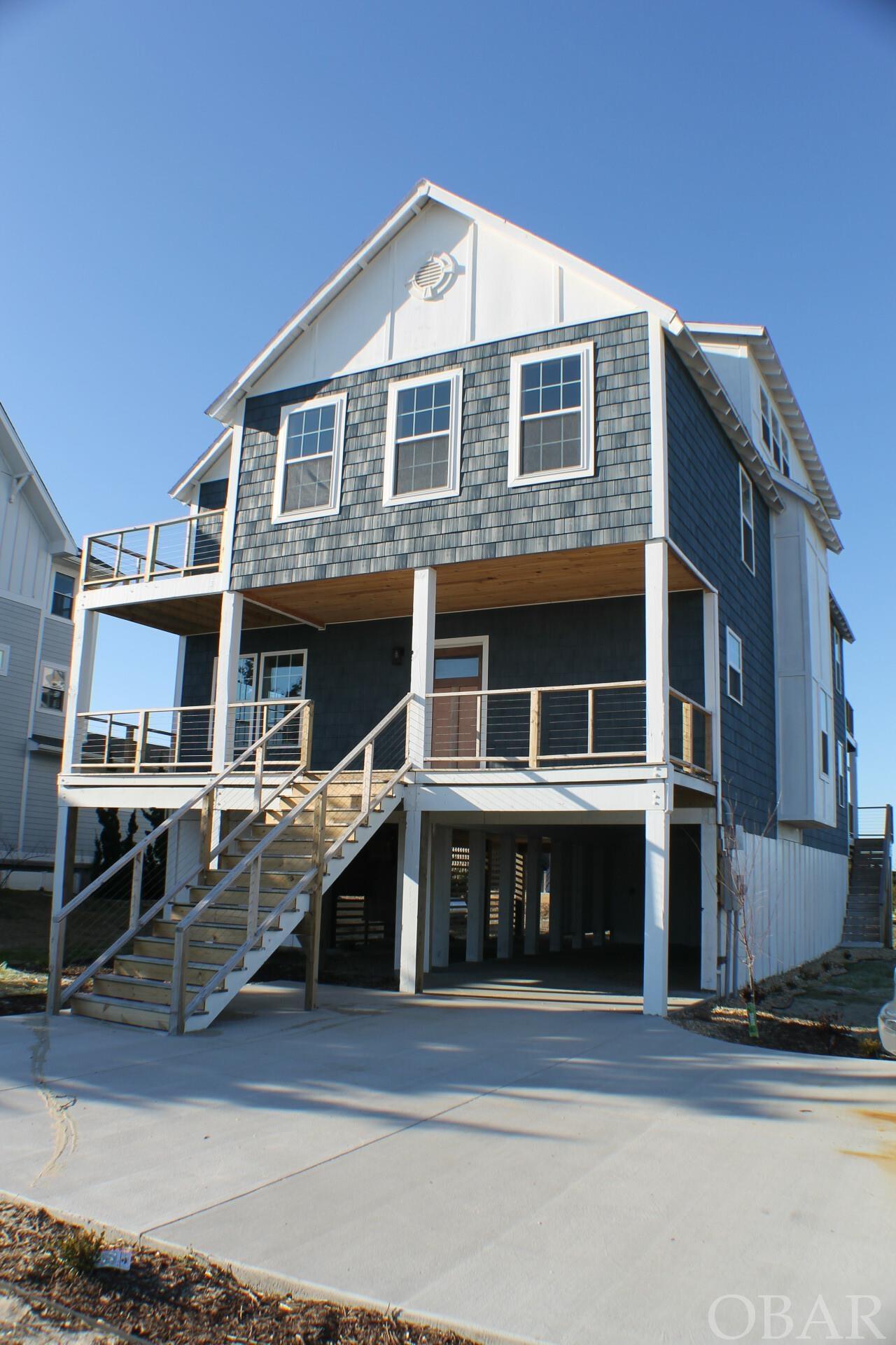 This sound-front home will make the perfect full time, vacation home, or rental property for any buyer. Built in 2022, it is ready for use. Pick out some paint colors to make it your own and start enjoying the Outer Banks first hand. This home boasts, brand new stainless appliances, hardwood floors throughout the entire home, tiled showers, 4 balconies and porches, 3 bedrooms, 3 bonus rooms, a massive lot of 28,500 sqft, and sound front access right in your backyard. The best part, is the water views from EVERY SINGLE ROOM. Approved for inground pool and dock.