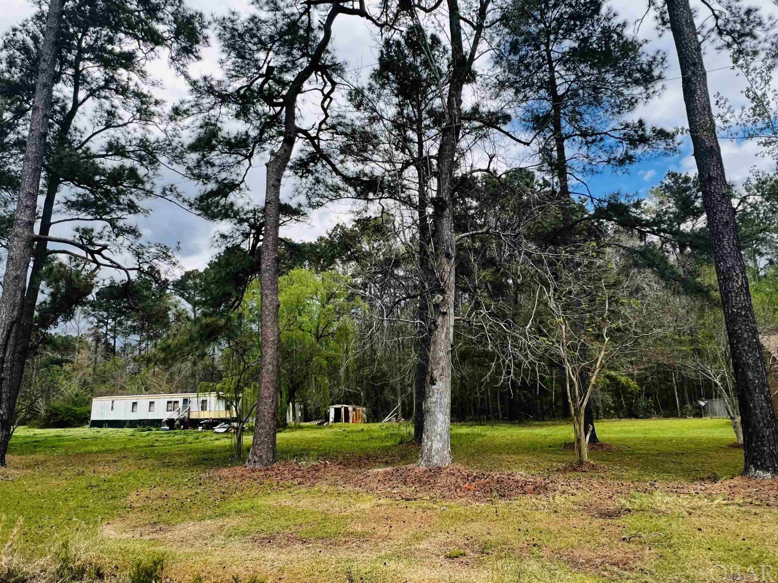 Great possibilities with 9.6 acres of land just waiting to be developed. Two miles from the Intercoastal Water Way, with several boat launching areas, into the Alligator River for the Fishing Angler. Just a short drive (20 minuets) to the Ocean and all it's amenities!
