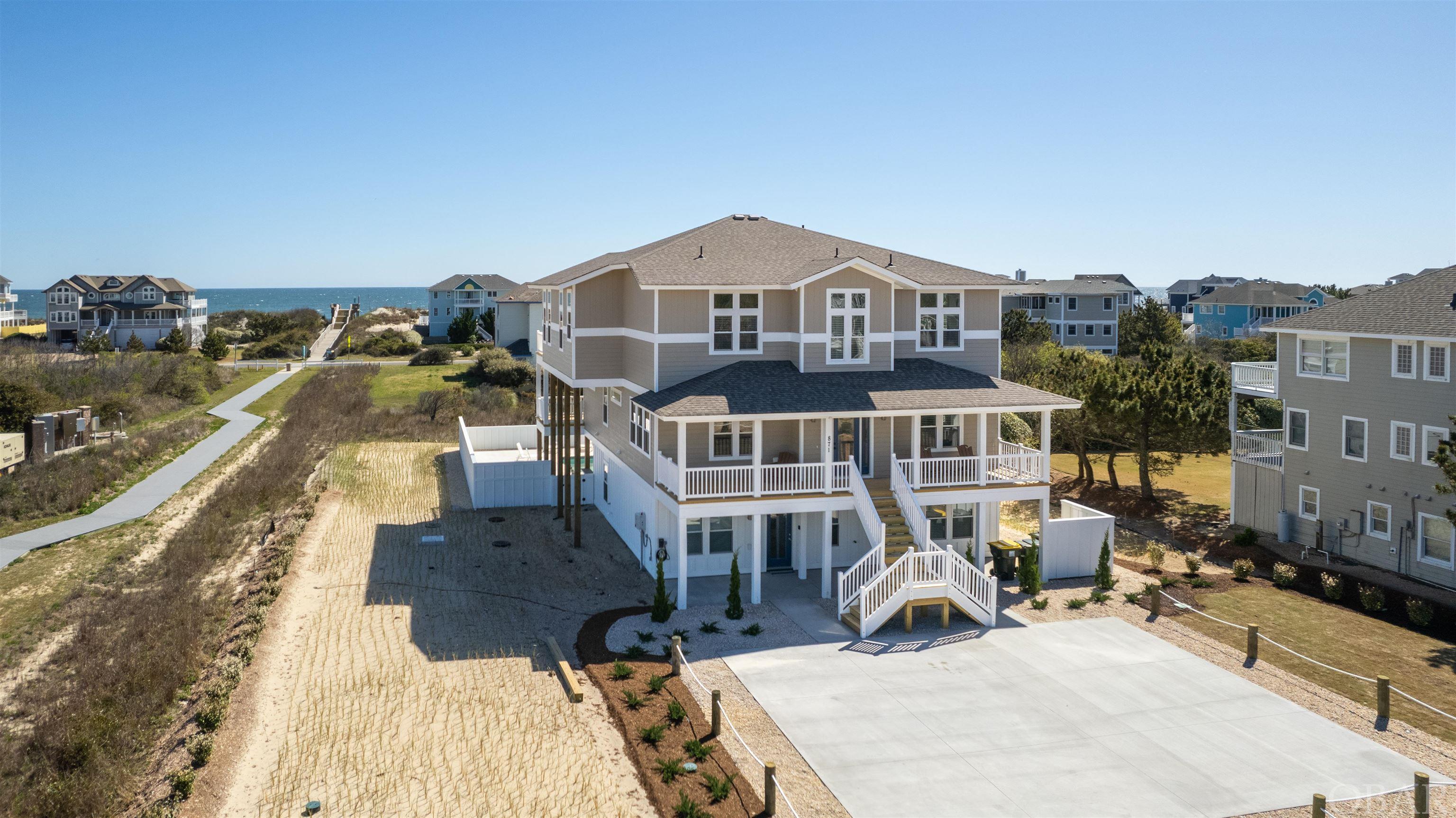 This is the one! Brand new construction for 2024, built by one of the area's premiere builders, Olin Finch. Stunning custom details throughout this one-of-a-kind home will surely delight you! The location is exceptional—only two lots back on the corner for direct and easy access to the beach! The open space to the beach walkway gives you more unobstructed ocean views.  Incredible views of the Atlantic from the great room will not disappoint!  With 12 ensuites, an elevator, a private pool and hot tub with a cabana bar, a game room, and 2nd a living area on the mid-level, this home is an investor's dream. It checks all the boxes for what you and your renters could want.  There is so much room for each member of the family to relax and unwind without feeling crowded. Professionally decorated with beautiful coastal accents throughout the entire home.  The top level features a large open great room overlooking the ocean and a chef's kitchen with 2 of every appliance, a center island, and a stunning, custom tile backsplash.  Modern and elegant electric fireplace in the great room.  The top level offers 3 generous ensuites.  You will find a family room and 5 more ensuites on the mid-level.  The ground level features a large game room and seating area, a kitchenette, and 4 more ensuites.  Every bedroom has a private bathroom.  The property has been beautifully and professionally landscaped.  The custom concrete pool features travertine coping, a cabana bar with a TV, and an oversized hot tub.   The state-of-the-art composite siding and vinyl handrails are made to last.  Durable and beautiful luxury vinyl plank flooring in all common areas is low maintenance. Starting to take bookings for the 2024 rental season now, ask to see the rental projection!