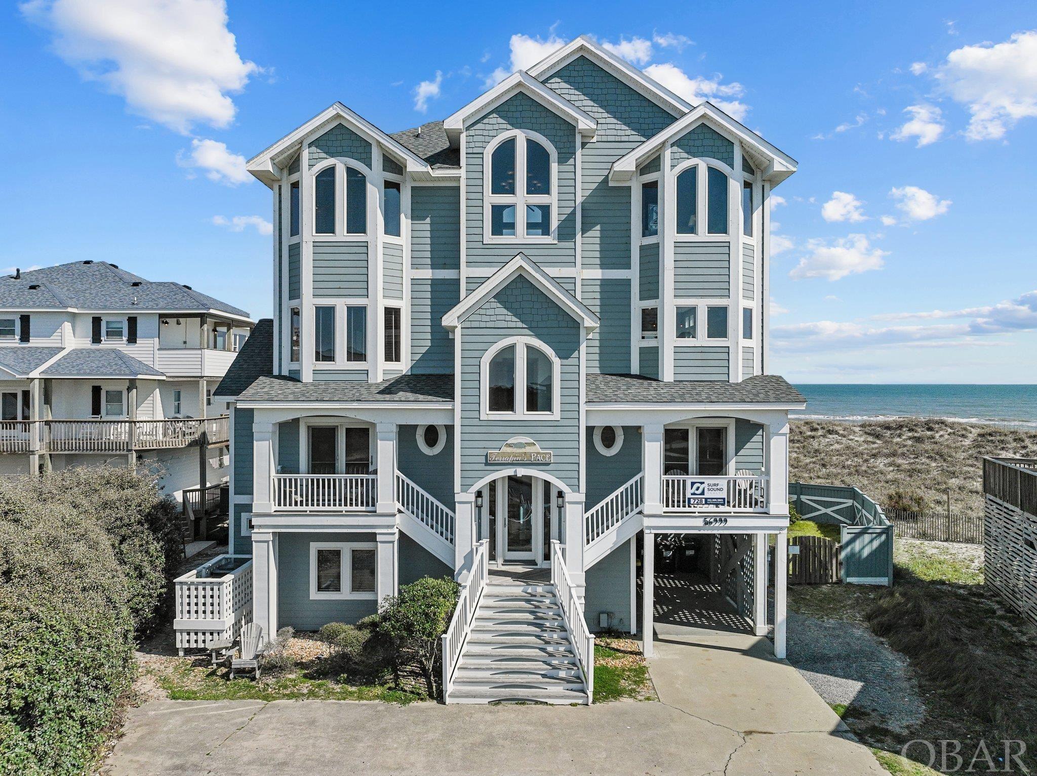 "Terrapin's Pace"; this opulent Oceanfront Home offers a unique 4 story custom design, provides everything guests and vacationers could desire, with stylish finish materials, and some of the most expansive and panoramic ocean views around….all just steps from the beach!  Providing all it does, in this location, this vacation home has always been a fan favorite, generating consistent high rental income, and has another great rental season booked for 2024.  Over $244k owner rental income during 2023, and already over $216k owner income for 2024, with room to grow. At  5,091 sf, (with elevator to all levels) this dramatic property offers tons of space and common areas to spread out and enjoy;  including 8 bedrooms, all primary suites for comfort and privacy & with mounted HDTV’s,  8 full and 2 half baths; multiple common areas include a fun recreation room with pool table, foosball, and kitchenette, a beautiful Oak paneled library / theater room, an expansive great / living / dining area overlooking the ocean, plus an additional den / media room on the 4th level, offering a wet bar & amazing dune, beach, and ocean views!  Outside enjoyment areas include ample decking all along the oceanfront to soak in the views, covered Soundside decking, and a backyard pool area that feels like your own Oceanfront private outdoor resort, with an expansive heated concrete pool,  custom in-ground hot tub, and great Tiki bar for outdoor entertaining.  Comfortable living in the great room with cathedral ceilings, reclaimed heart pine floors, large dining area, all with wide ocean views, and a large gourmet kitchen with custom cabinets, granite counters, and upgraded stainless steel appliances, including double wall ovens, double d/w's, gas range.  Each bedroom has it’s own style, each bath features custom designed tiles, and the luxurious top level King Suite features private oceanfront deck and large upscale custom bath.  At Terrapin’s Pace, you'll experience dramatic and commanding views from all over the home, enjoy all the desired amenities inside and out, just steps from the beautiful beaches of Hatteras Island. Offered fully furnished, equipped, and accessorized with attractive coastal decor. In a great location, close to the fun and conveniences of Hatteras Village, home to the fishing fleet, headboats, restaurants, shops, and easy access to the 4x4 beaches and Ocracroke Ferry.  Homeowners have made many significant updates to the home recently, in quality minded fashion, Update List available.  Make a point to view additional pictures and 3D Virtual Floorplan Tour at: https://listings.lighthousevisuals.com/sites/yqkrvqk/unbranded