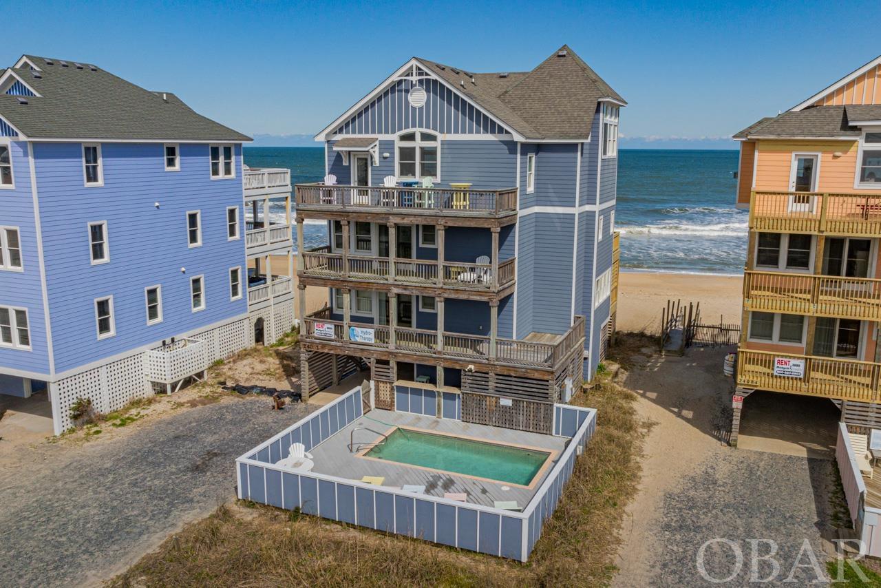 All we can say is WOW! Dive into the pinnacle of coastal luxury at Hydro-Therapy, a masterpiece nestled right on the Rodanthe Oceanfront. This 5-bedroom, 5 full and one-half bath residence promises unparalleled elegance and comfort, alongside breathtaking updates. Every morning, wake up to mesmerizing ocean and sound views that craft a tranquil start to your day. When it comes to amenities, Hydro-Therapy is unmatched: dive into the pristine private pool, soak in the therapeutic hot tub, or freshen up with an outdoor shower after a sandy day at the beach. Inside, the home boasts a state-of-the-art game room complete with a wet bar, perfect for challenging your friends or enjoying a night in. Navigate effortlessly between the home's levels with the built-in elevator, ensuring accessibility and ease for all guests. The options for relaxation and entertainment are abundant, whether you're sunbathing on the sunny deck or finding solace under the covered deck. Recent enhancements include the replacement of the east decks, repaired west decks, replaced sliding doors, windows, and siding on the east wall, alongside new exterior outlets and light fixtures, reflecting our commitment to excellence. The bedrooms are airy sanctuaries, ensuring a restful night. Central to the home is the breathtaking great room, where cathedral ceilings soar high and floor-to-ceiling windows frame the expansive ocean.  Culinary enthusiasts will adore the gourmet kitchen, decked out with sleek stainless steel appliances and polished granite countertops. But the allure of Hydro-Therapy isn't just in its features. Its prime location places it a stone's throw from the iconic Rodanthe Pier, with the vibrant village heartbeat filled with shopping, dining, and entertainment options just a short walk away. As an investment, Hydro-Therapy shines too, boasting an impressive $166,000 in rental history for 2023 and already $162,000 on the books for 2024. Hydro-Therapy isn't just a residence; it's an invitation to a dreamy coastal life. Seize this once-in-a-lifetime opportunity and make this slice of paradise yours today.