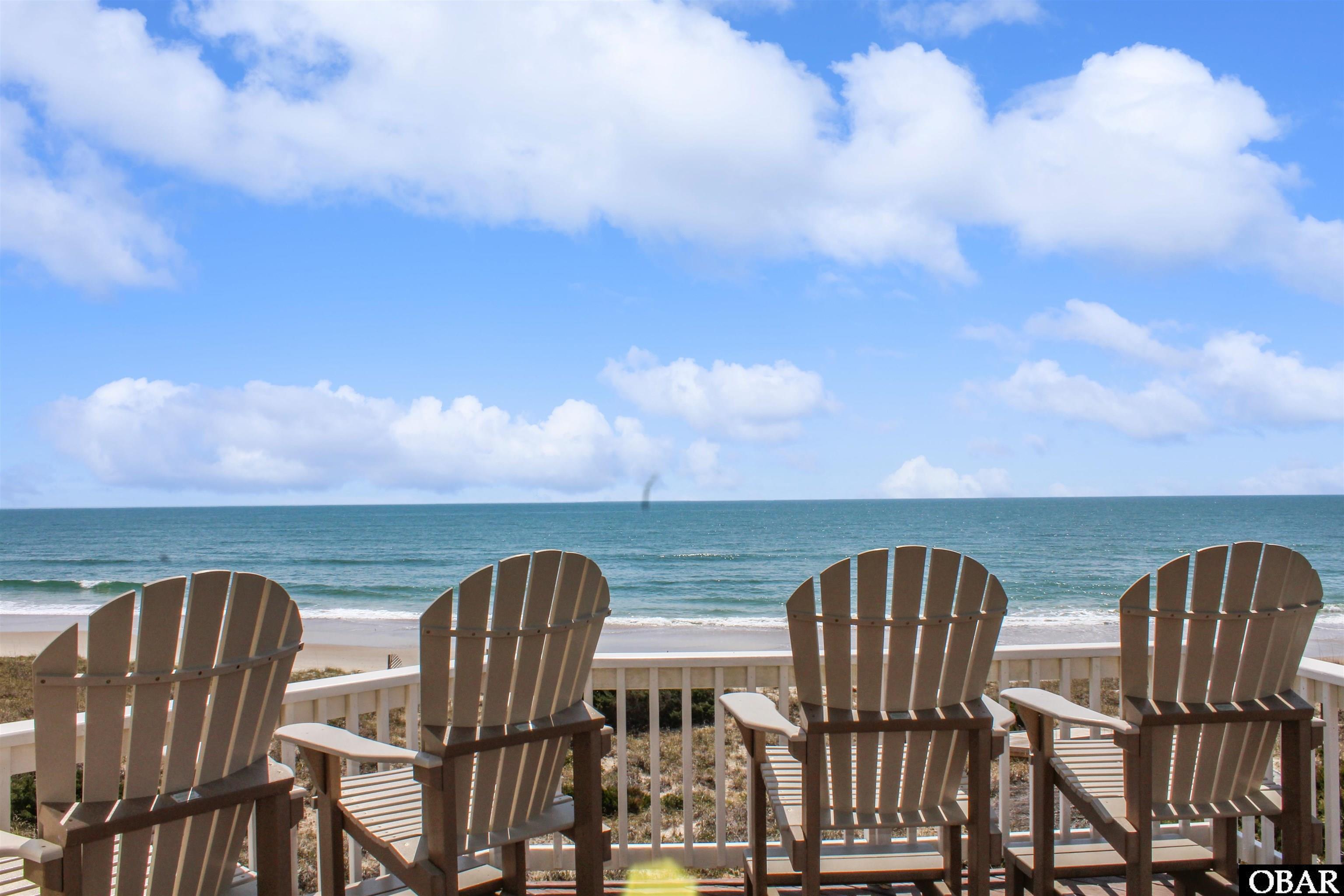 From the top east deck of 'Landfall' at 58055 South Beach Ct, enjoy sweeping ocean views and the serene beauty of Hatteras, NC. Perfect for sunrises and relaxing coastal moments