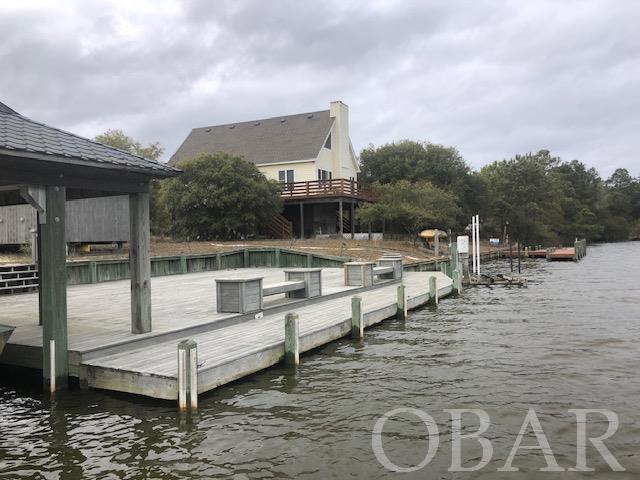 Own a piece of the beautiful Outer Banks 4x4. Build your dream home on a lot that has it all - it is just a short distance to the Beach and has easy access to the Sound. This is the lot that you've been waiting for -  it offers an expansive dock with entertainment  area, seating, ramp, boathouse, boatlift, wave runner lift with tranquil water views and privacy. If you are looking for a Lot with privacy on a canal, southern exposure and a short distance to the beach, this is the lot for you.