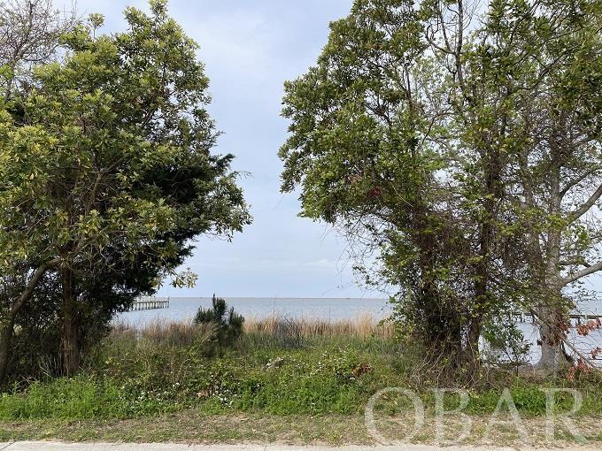 Let your dream of living waterfront become a reality. This premier location nestled in the heart of the Outer Banks on Bay Drive in Kill Devil Hills. A perfect canvas to custom build awaits you. This lot provides an unmatched blend of waterfront location and easy access to all of the local amenities. A corner lot approximately 50x140 and comes with two parcels on the soundfront. The public boat ramp is just a short distance South of this property for an easy launch of all of your water toys. Take advantage of the multiuse path that spans from the end of Kill Devil Hills all the way to the Wright Brothers Monument. There are not many lots left on Bay Drive! Call today before this one passes you by